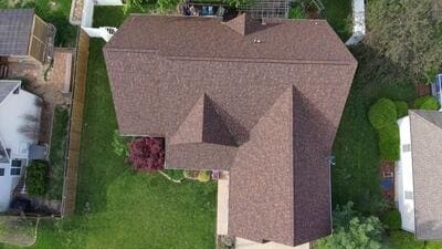 Aerial view of a deteriorated roof with extensive holes