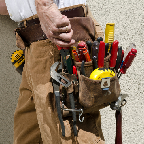 a pic of a man carrying a handyman tool belt