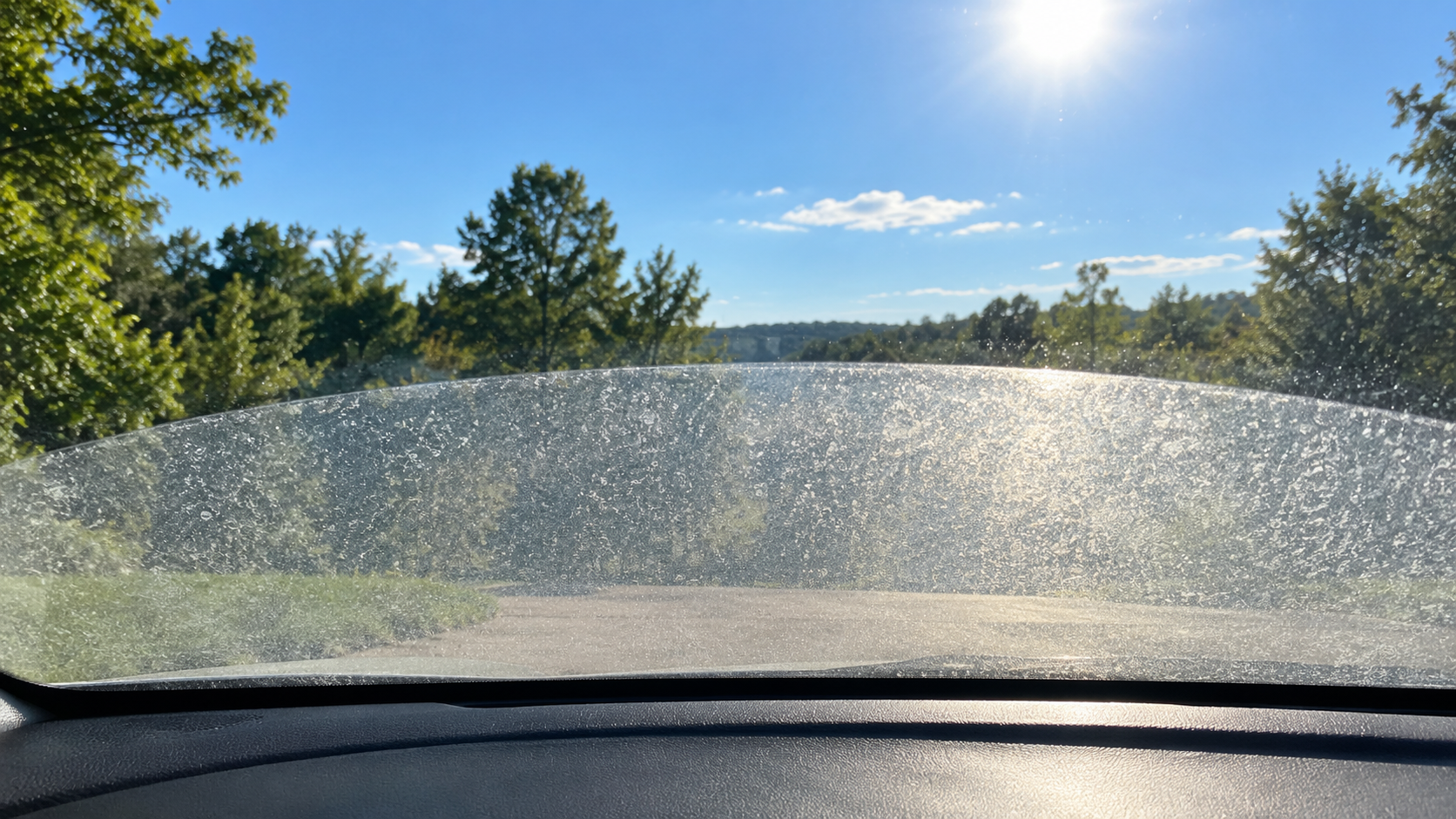 Hard water etching on auto glass along the wiper sweep beside clear glass