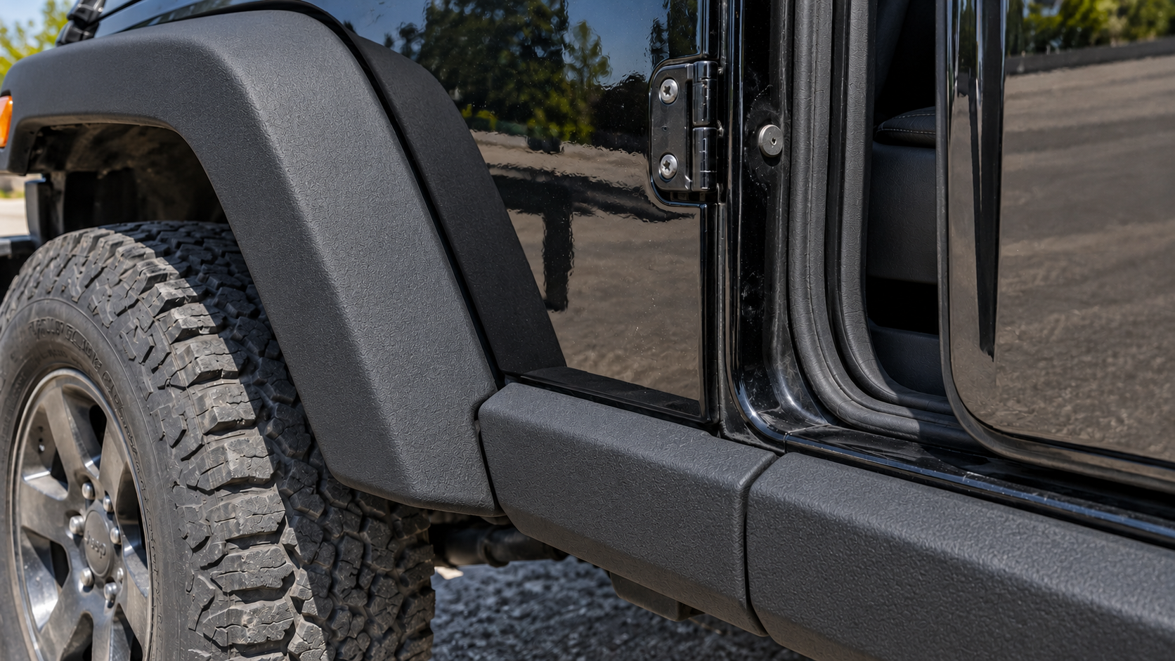 After: the same Jeep Wrangler trim restored to deep even satin black