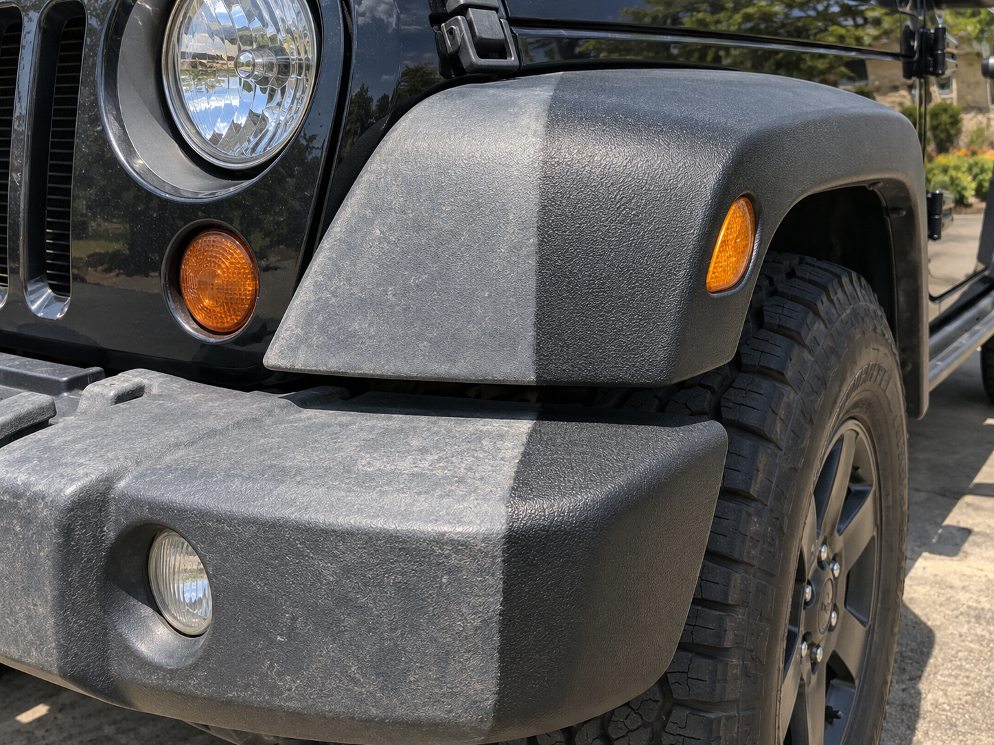 Half-restored Jeep Wrangler fender flare, chalky grey on one side and deep satin black on the other