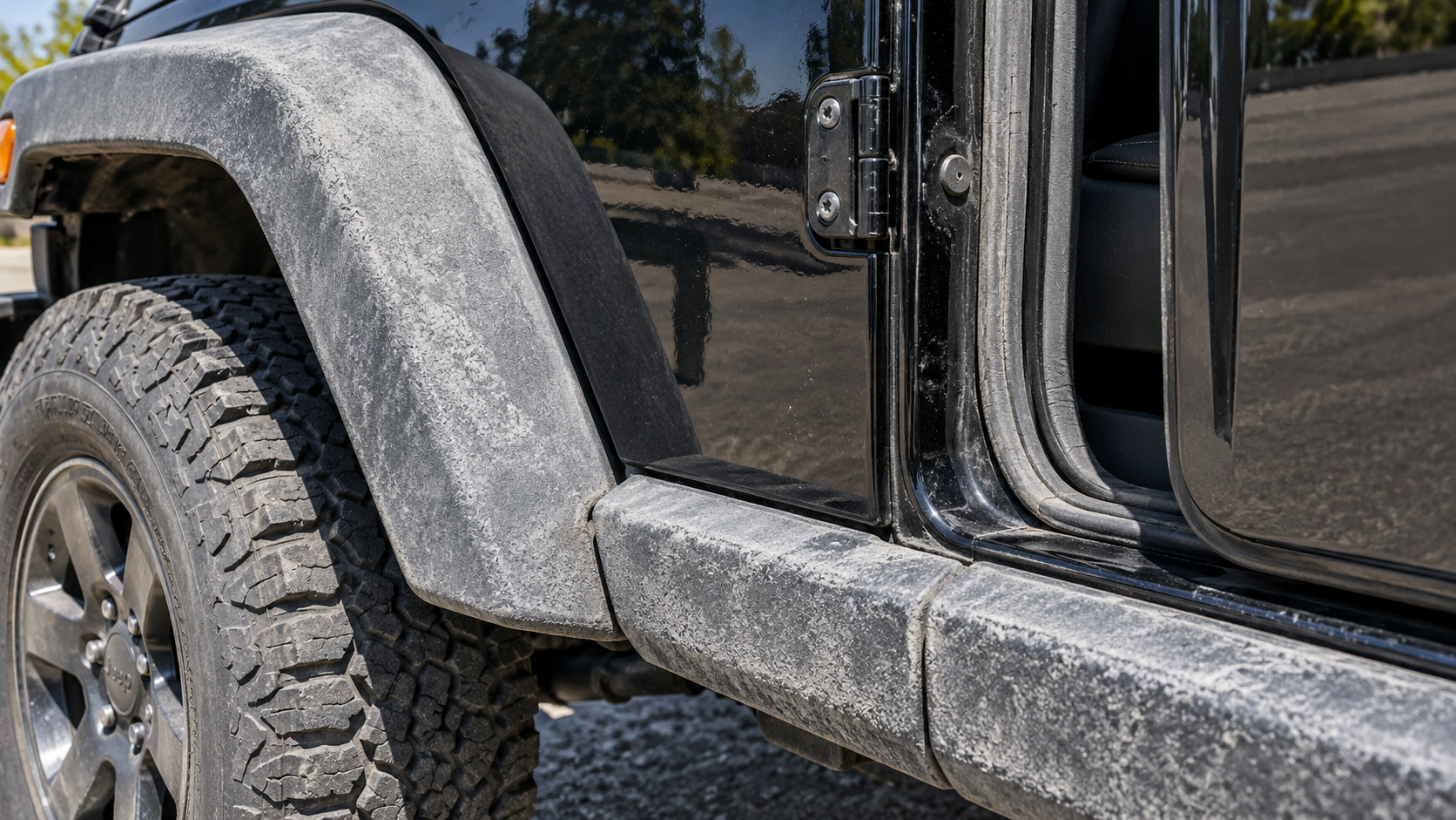 Before: UV-chalked fender flare, rocker cladding and faded door seal on a Jeep Wrangler