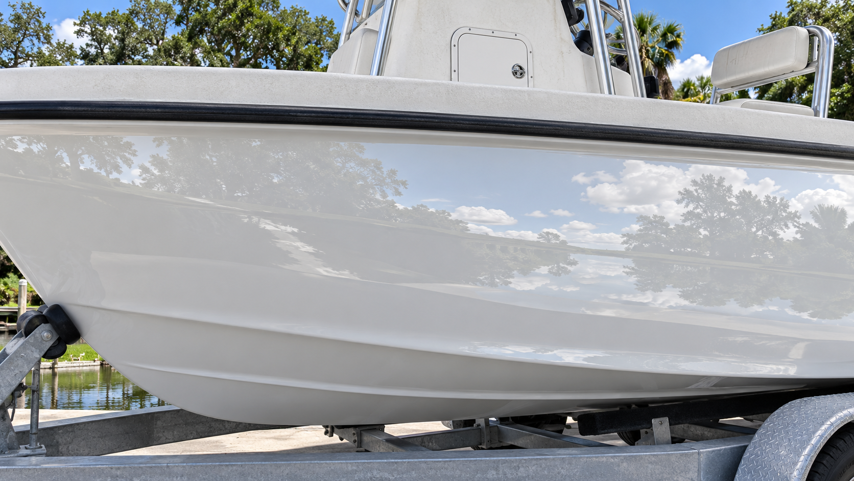 Boat hull polished to a mirror up to the rub rail, deck above untouched
