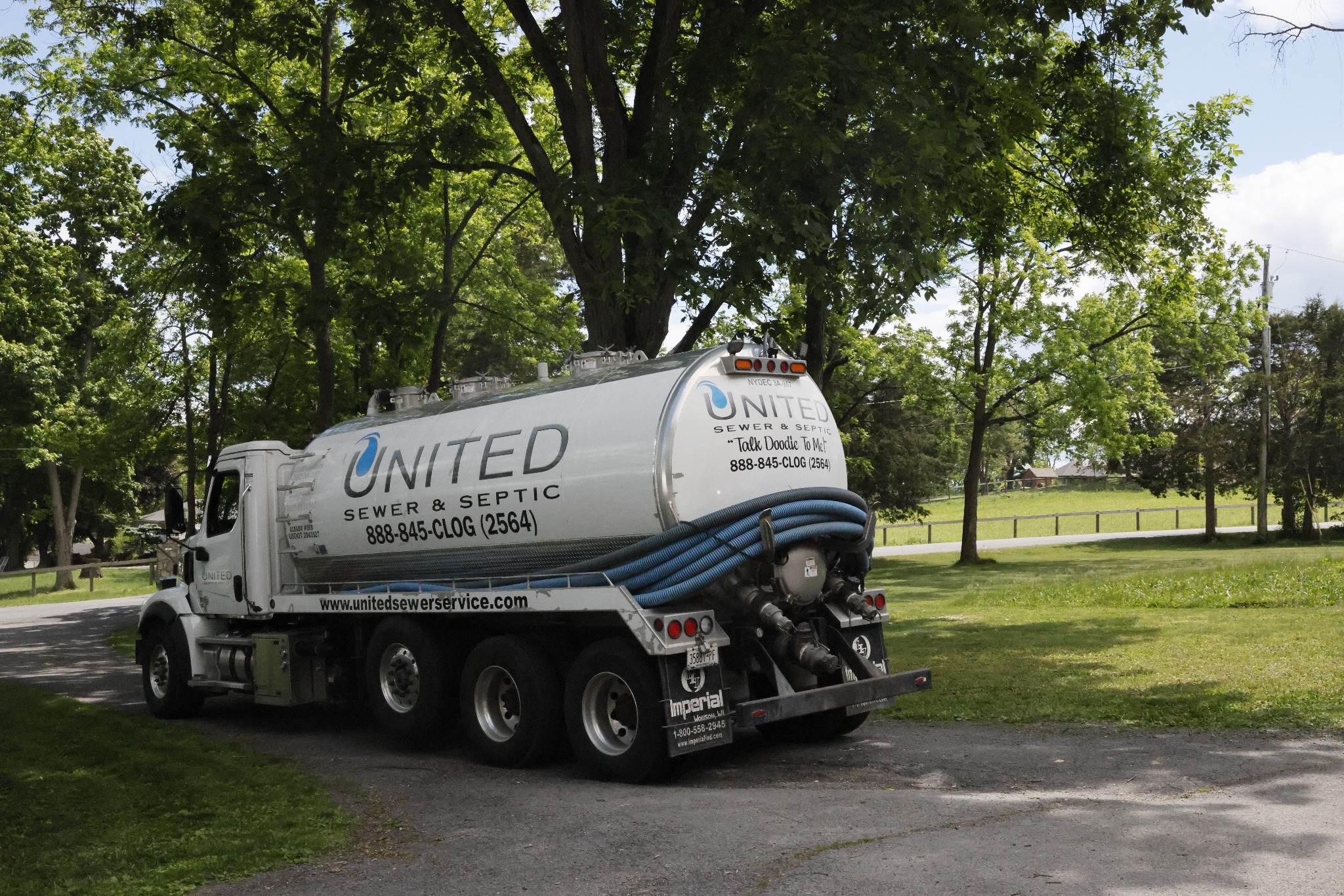 United Sewer and Septic tanker truck parked on a country road