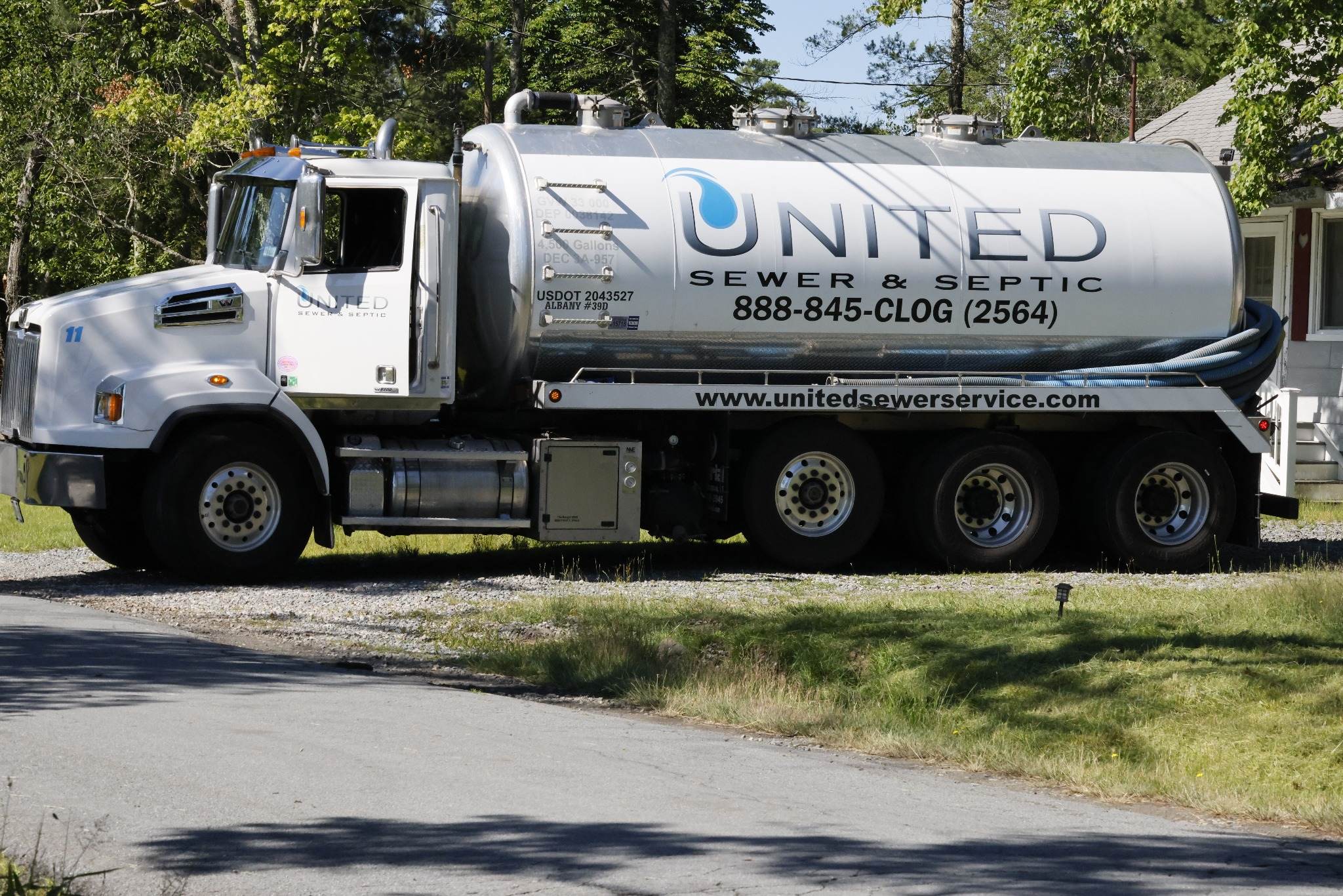 United Sewer and Septic septic pumping truck in a driveway