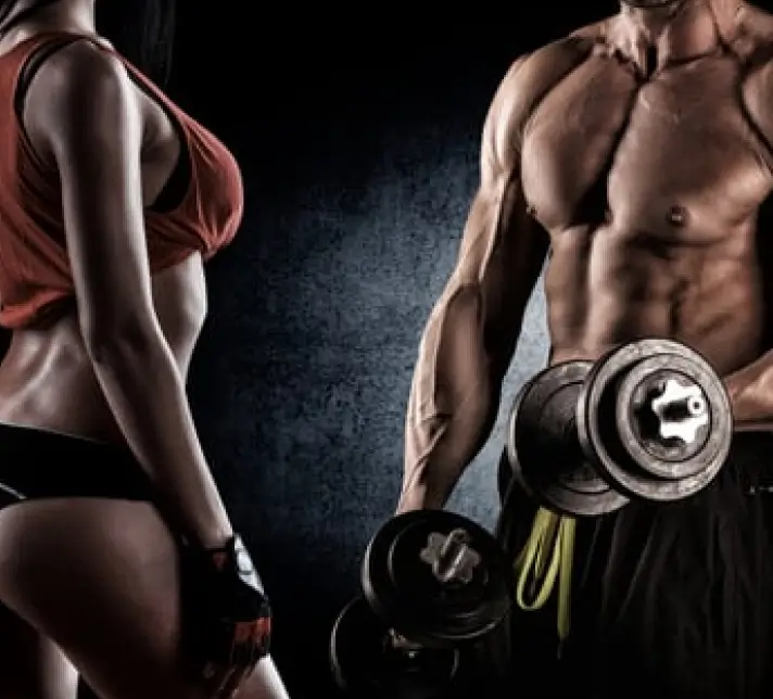 Two fit individuals in athletic attire stand side by side, holding dumbbells. Their muscular physiques are highlighted by dramatic lighting.