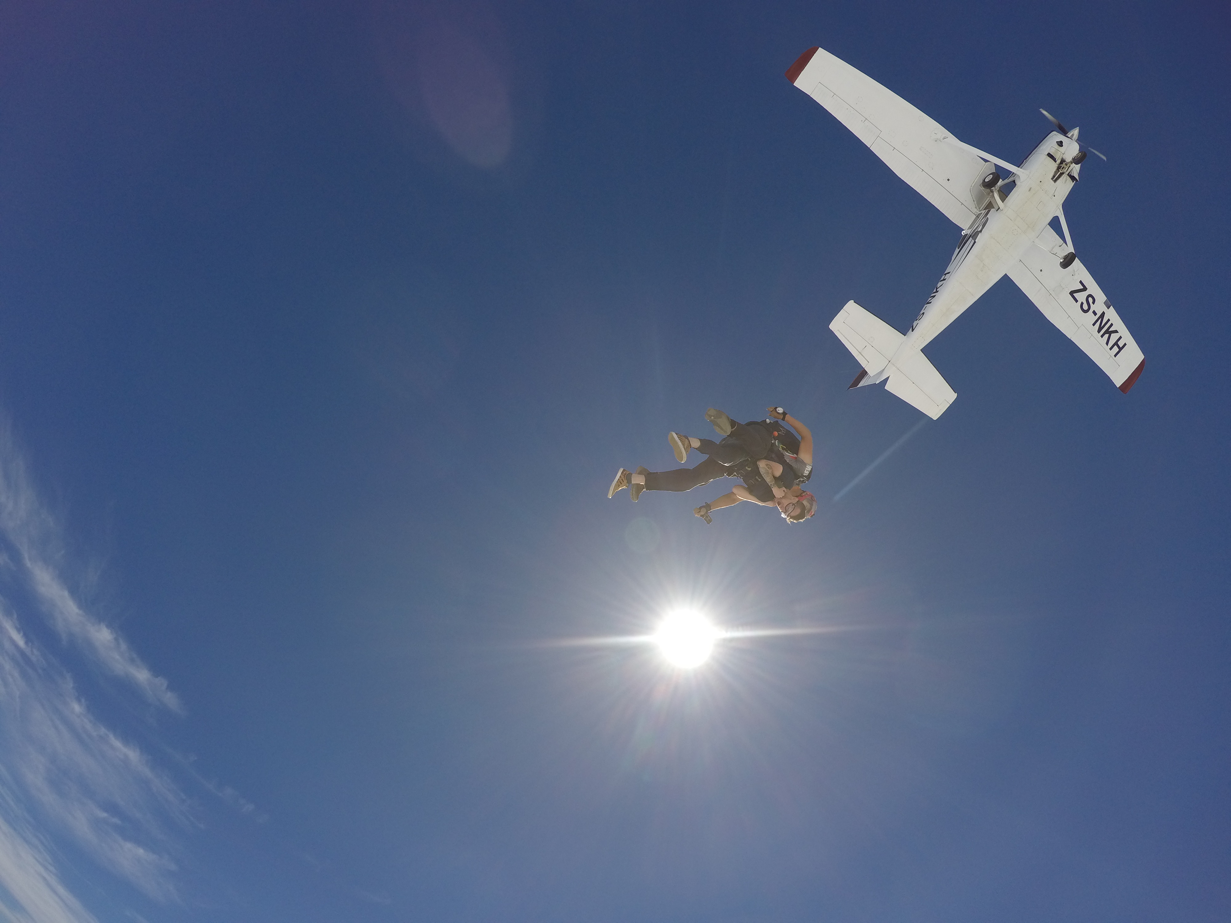 Tandem skydiving experience above the Cape Town coastline.