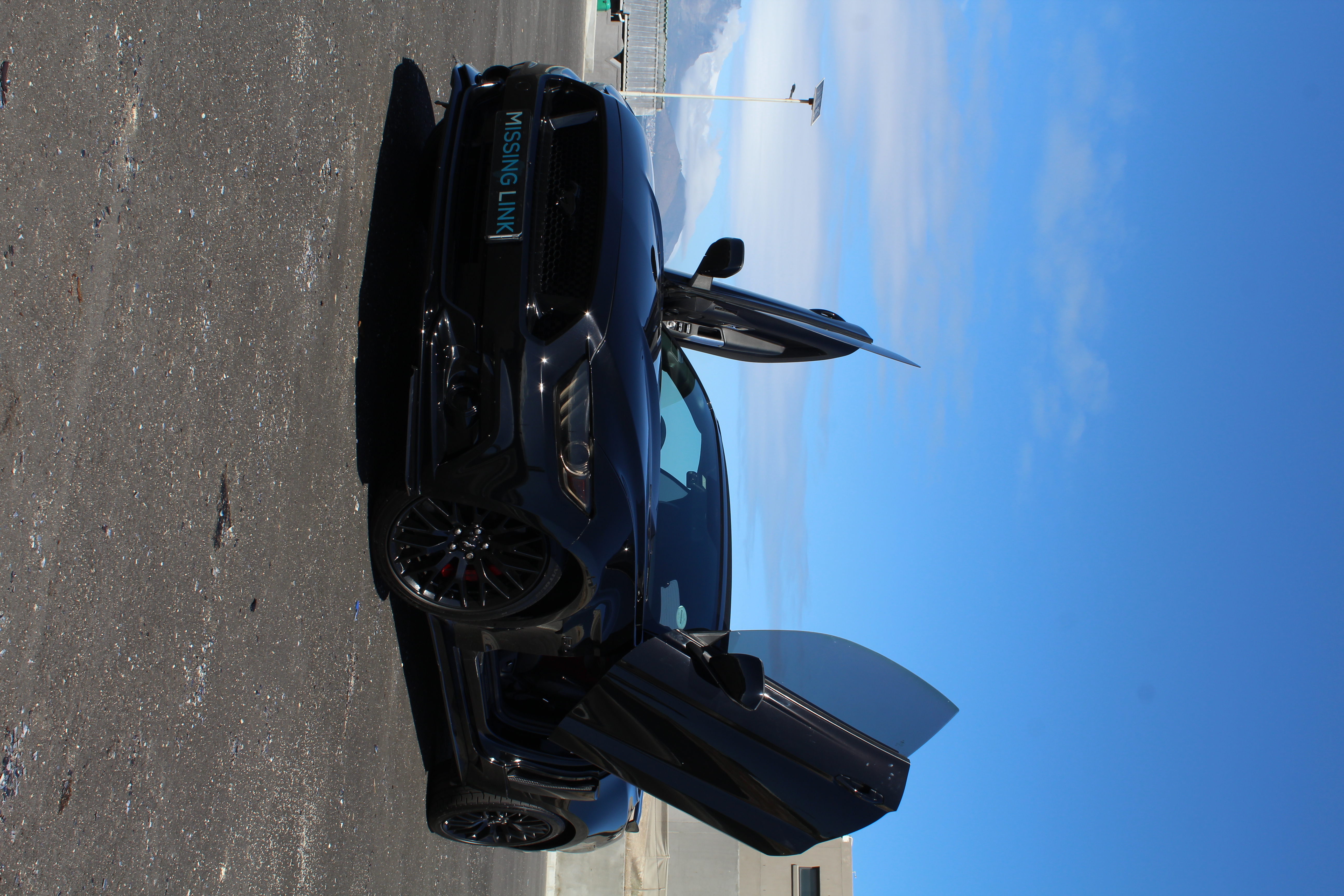 Black 2018 Ford Mustang 5.0 V8 Convertible front view for hire in Cape Town.