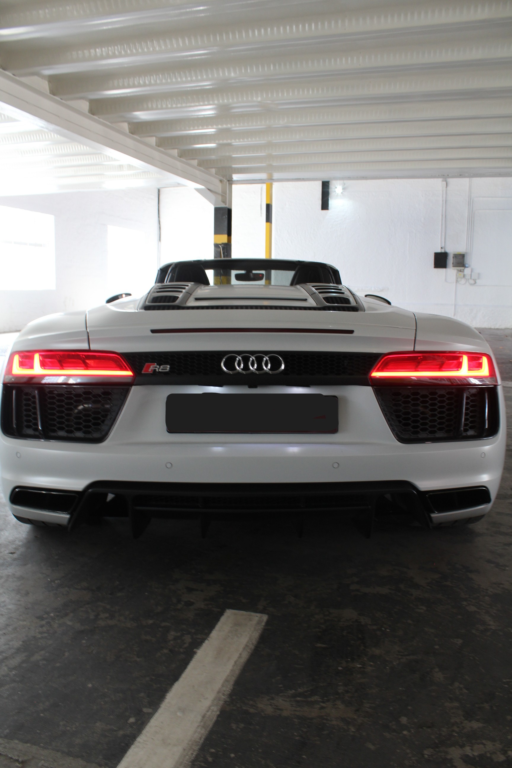 White 2019 Audi R8 Spyder V10 Convertible rear angle.
