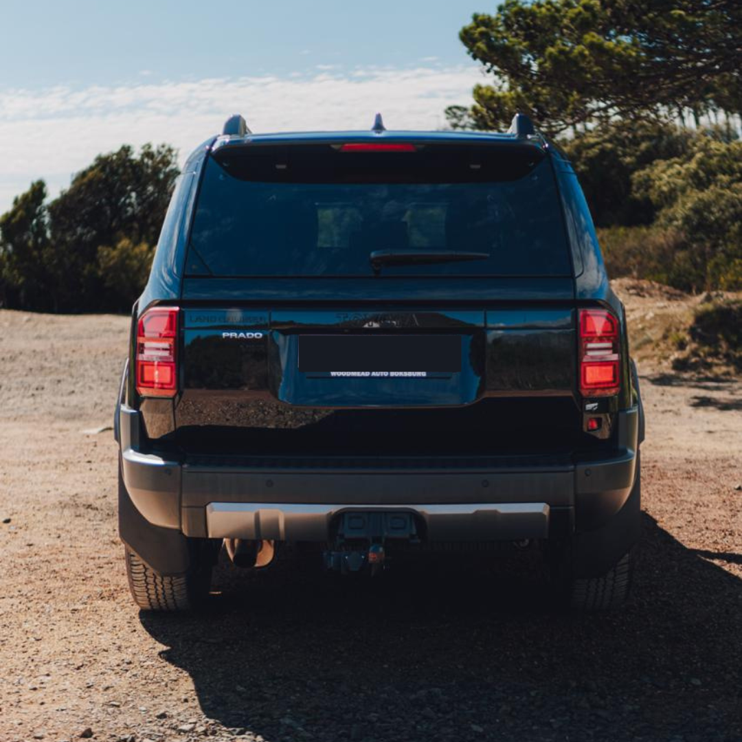Black 2025 Toyota Land Cruiser Prado VXR rear three-quarter view for hire in Cape Town.