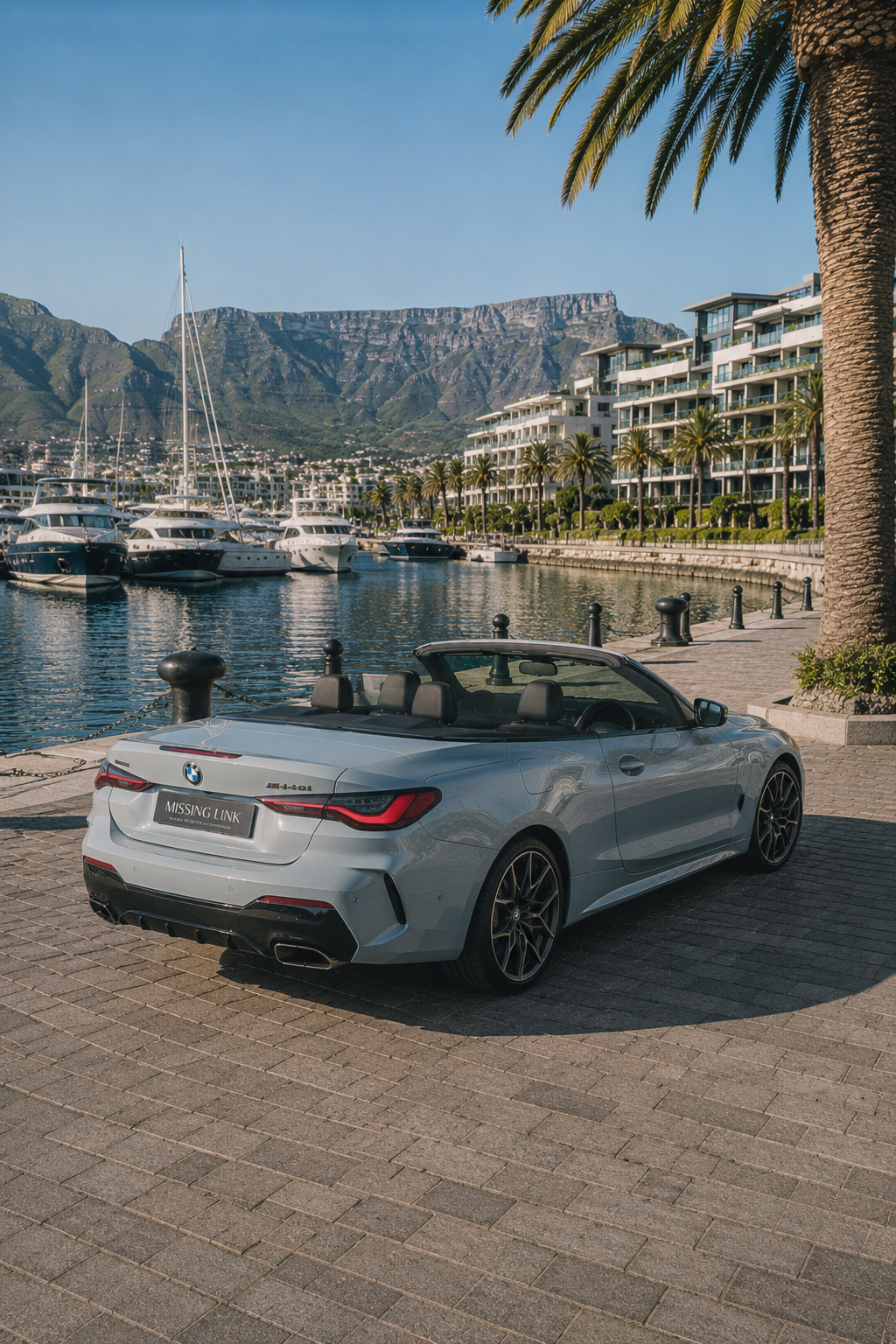 Rear angle view of the grey 2024 BMW M440i xDrive at the marina