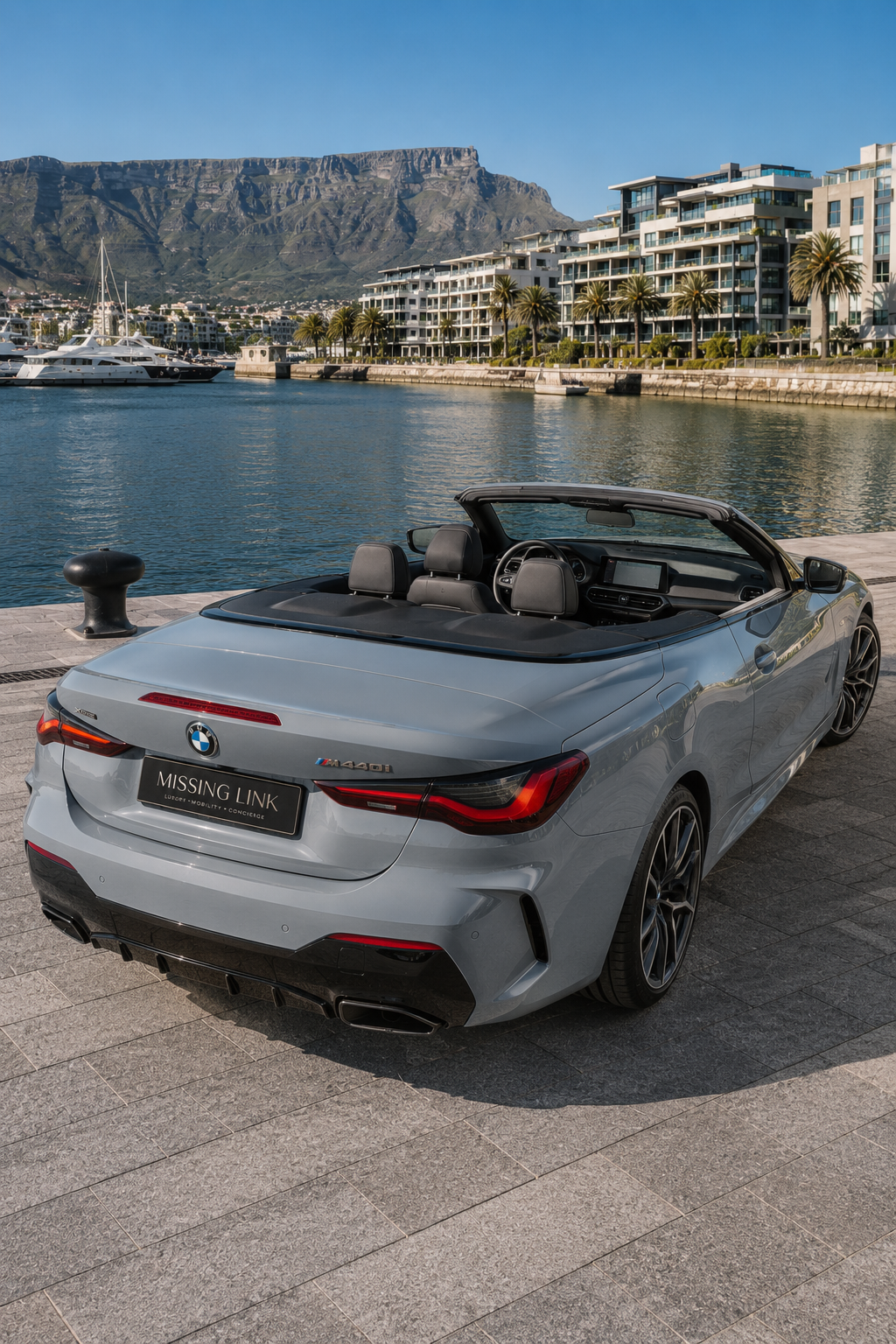Rear three-quarter view of the grey 2024 BMW M440i xDrive