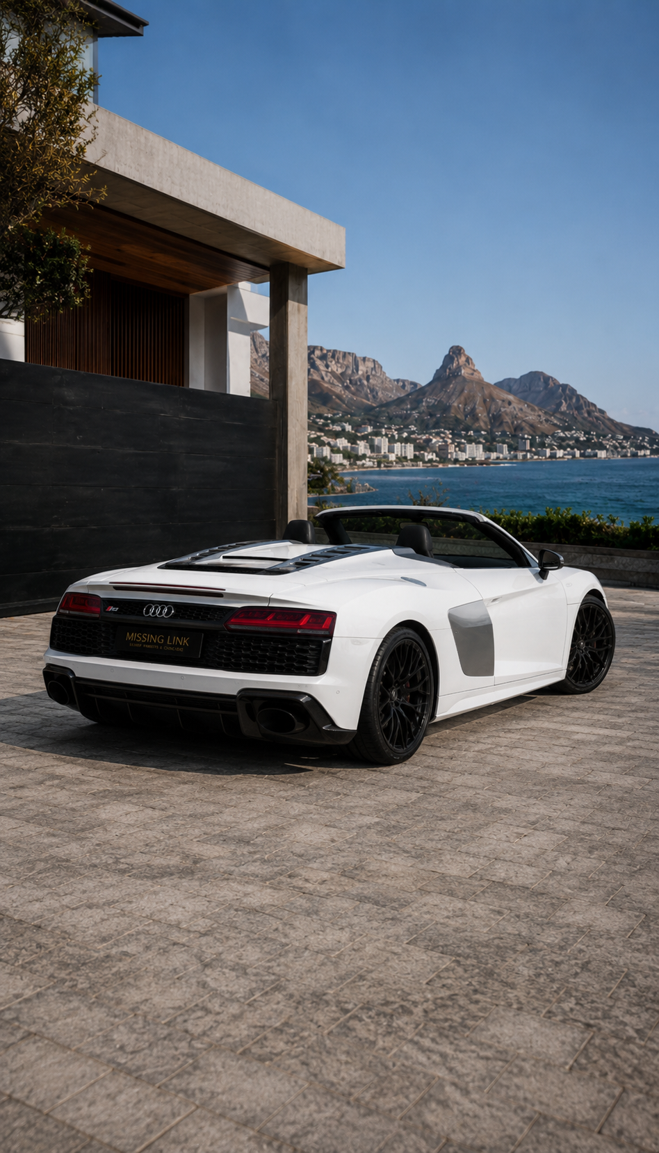 Rear three-quarter view of the white 2019 Audi R8 Spyder V10 Convertible