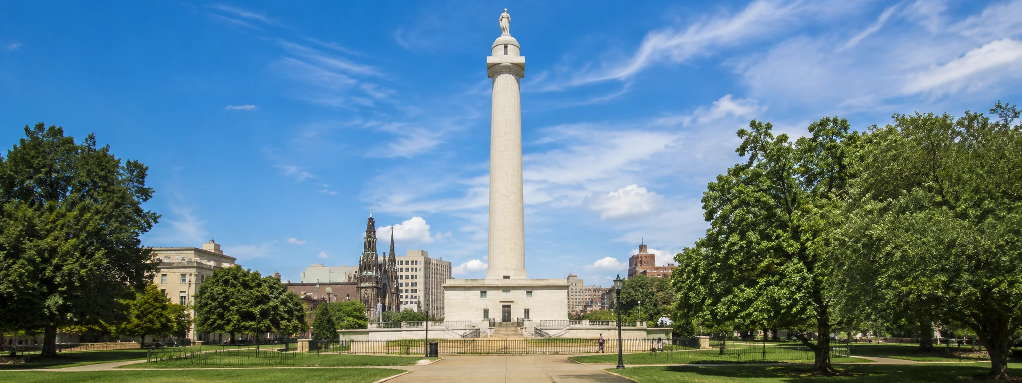 Washington Monument in Baltimore, Maryland surrounded by Mount Vernon park and downtown city views
