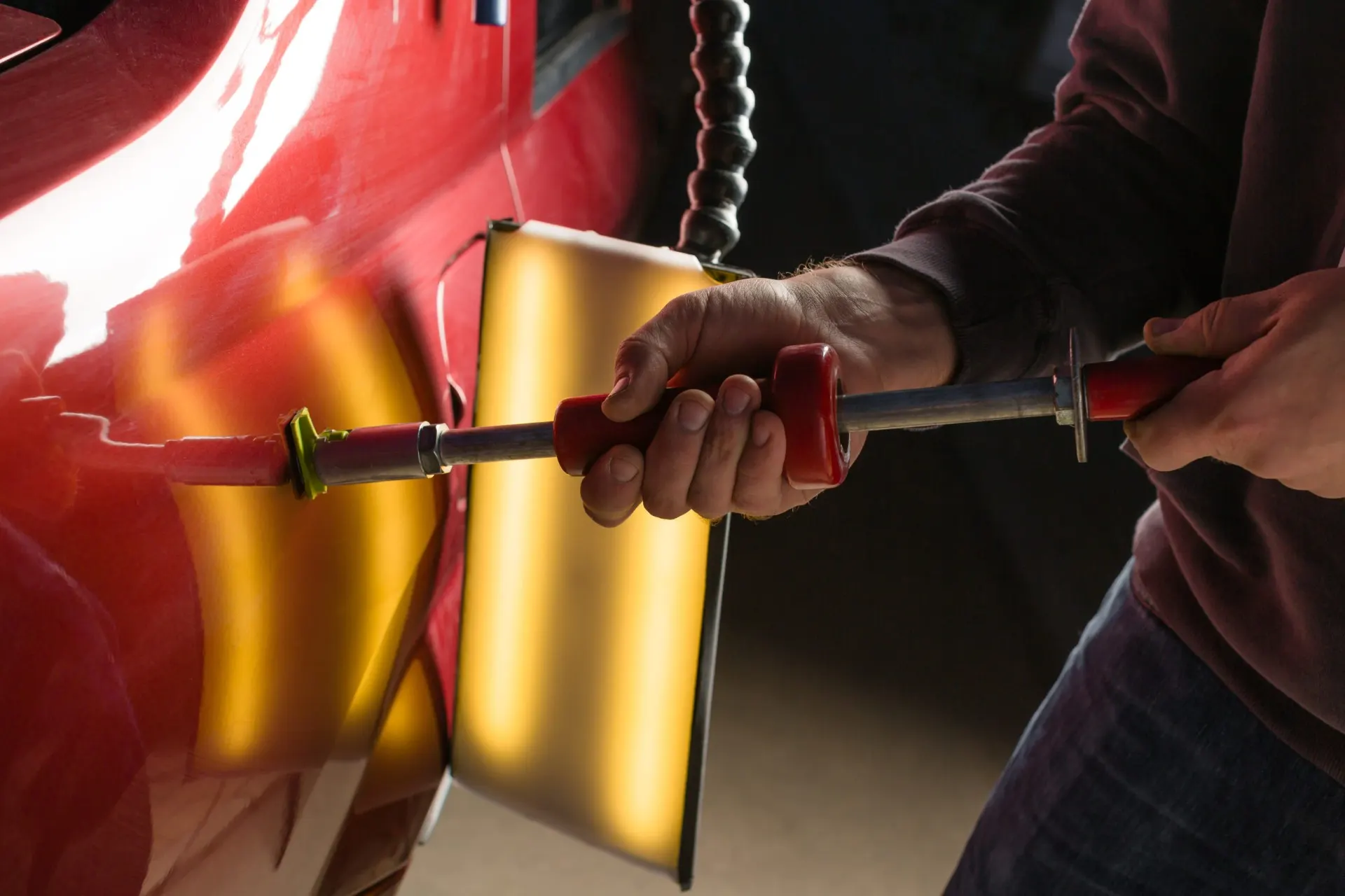 Technician performing paintless dent repair