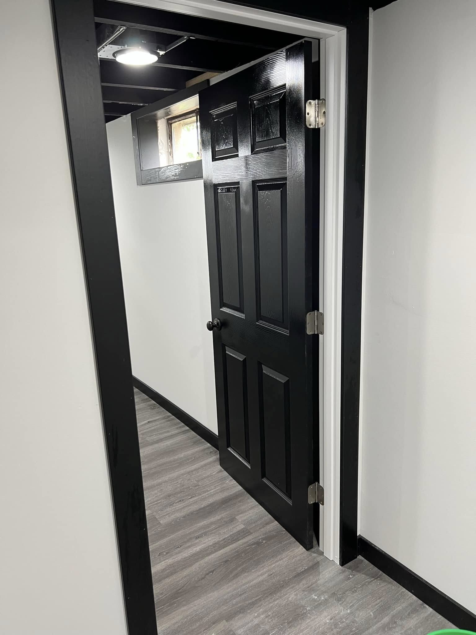 Black interior door and finish trim in a Bloomington, Illinois basement remodel