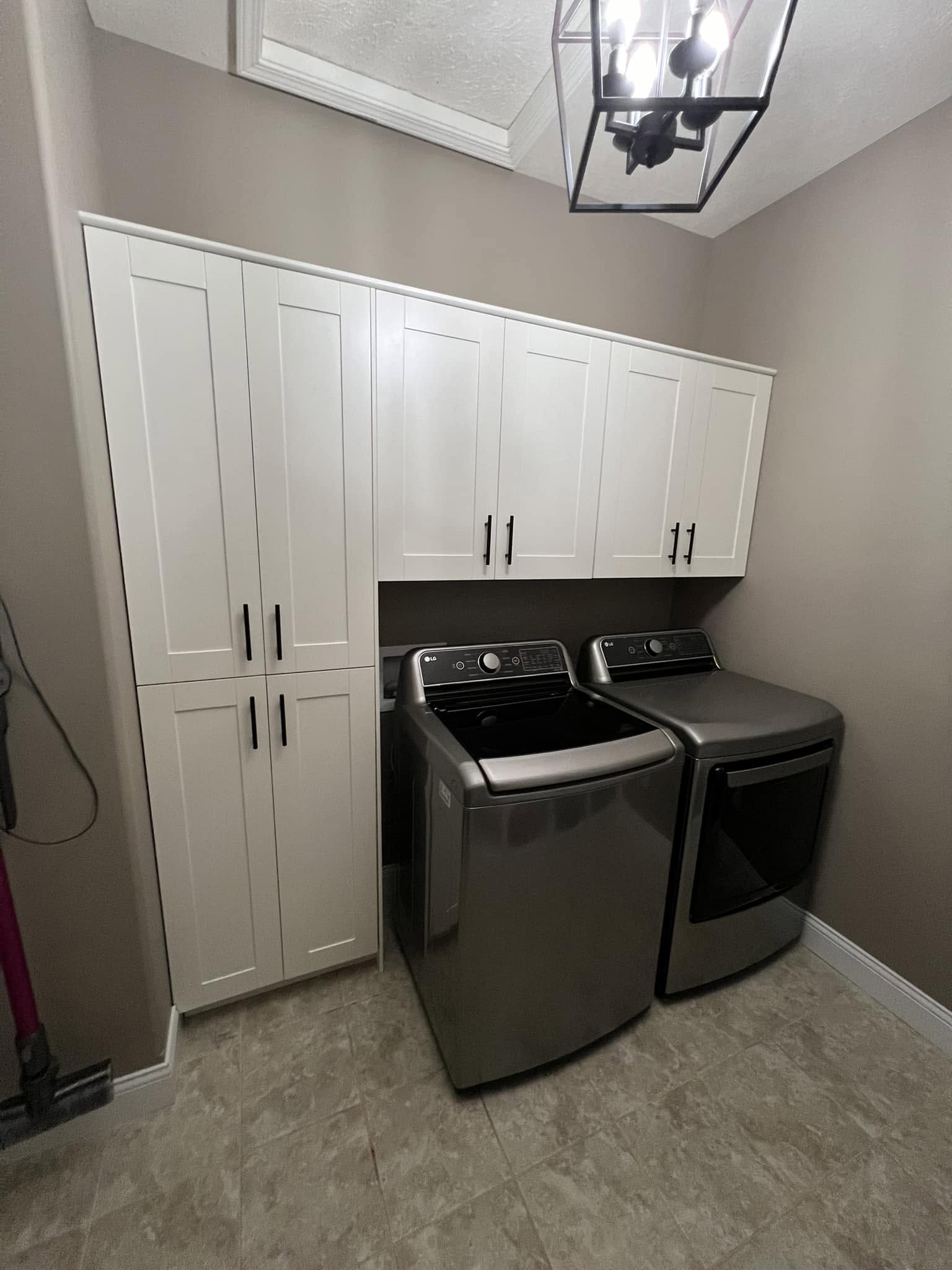 Custom white storage cabinets in a laundry room remodel in Normal, Illinois