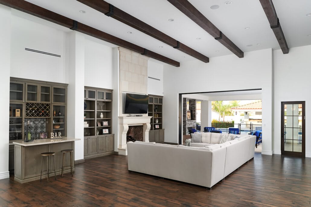 Living room with fireplace and home bar after a whole home remodel in Bloomington, Illinois