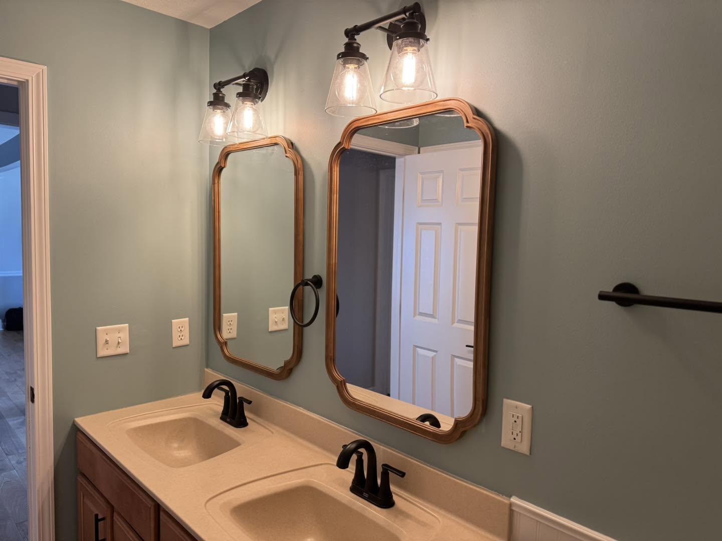 Double sink vanity with mirror lighting in a Bloomington, Illinois bathroom remodel