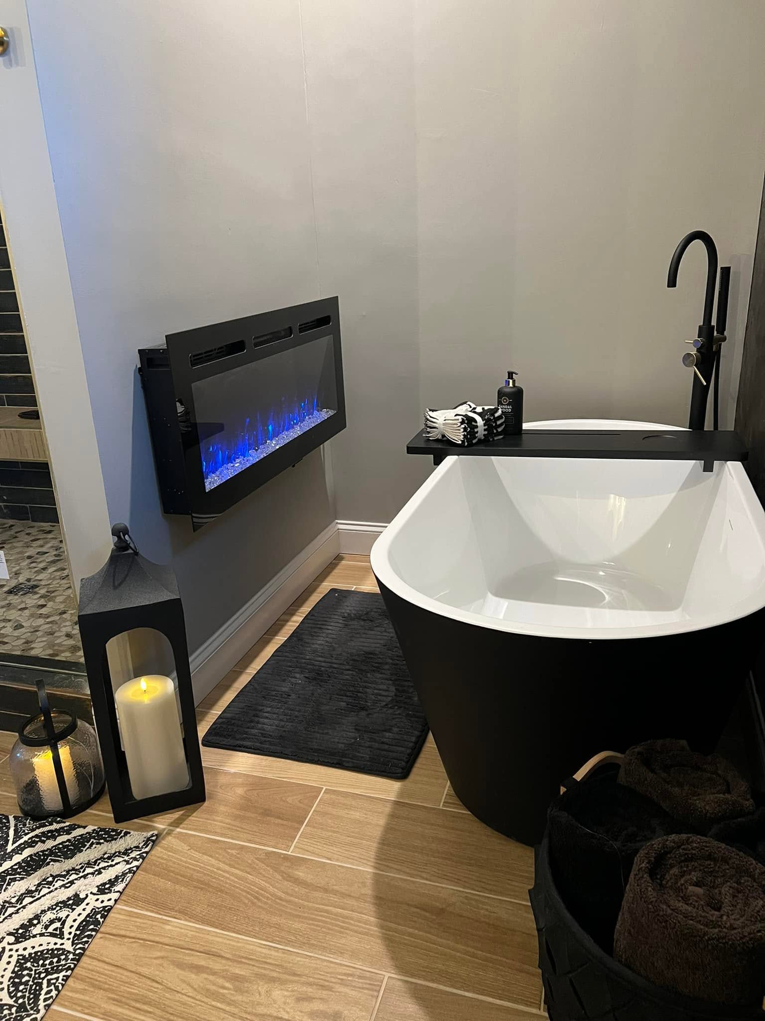 Freestanding tub and electric fireplace in a Normal, Illinois bathroom remodel
