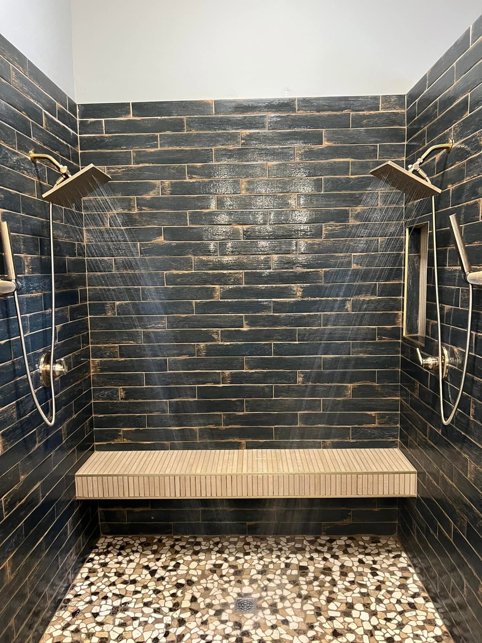 Tile shower with dual shower heads and a bench in Normal, Illinois