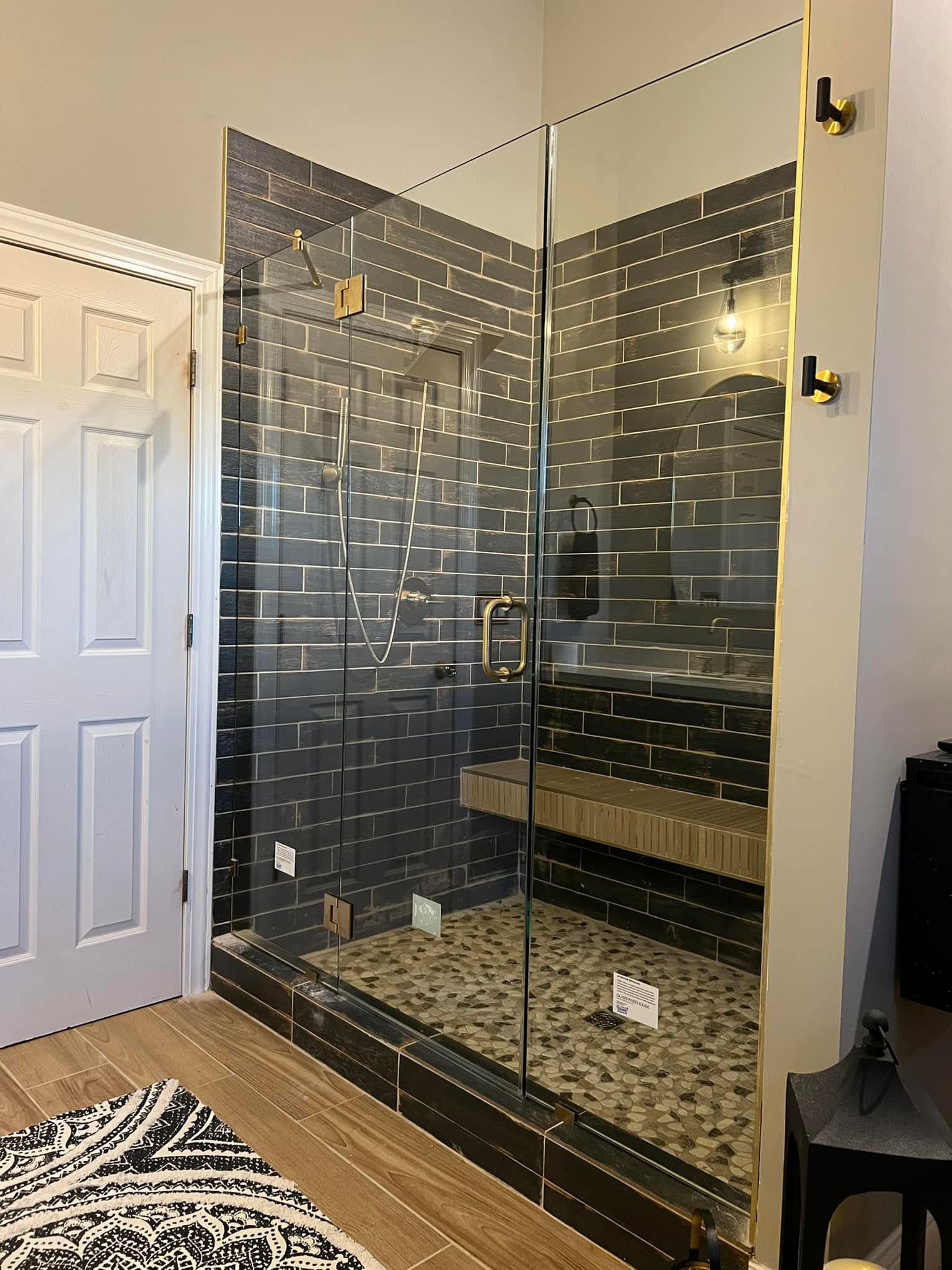 Glass walk-in tile shower with a built-in bench in a Normal, Illinois bathroom remodel