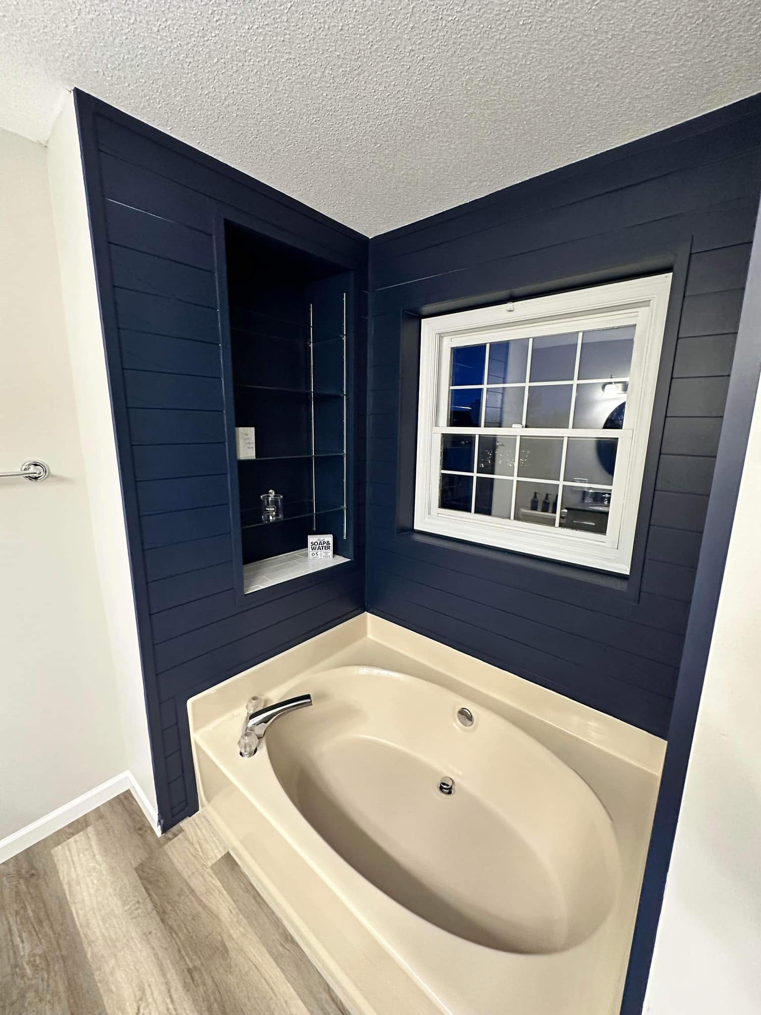 Jetted tub with navy shiplap wall in a Bloomington, Illinois bathroom remodel