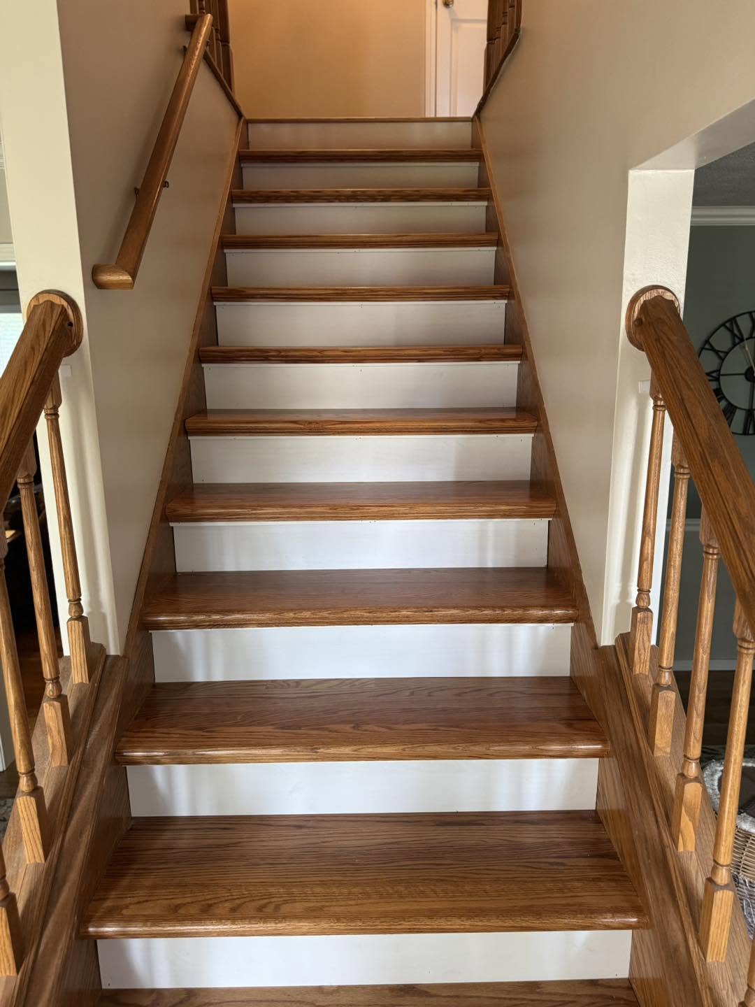 Refinished hardwood stair treads and white risers in Normal, Illinois