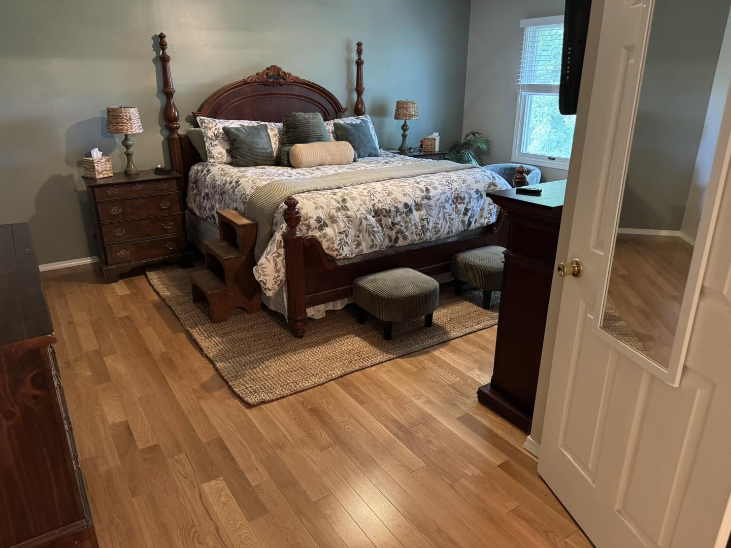 Refinished hardwood flooring in a primary bedroom in Bloomington, Illinois