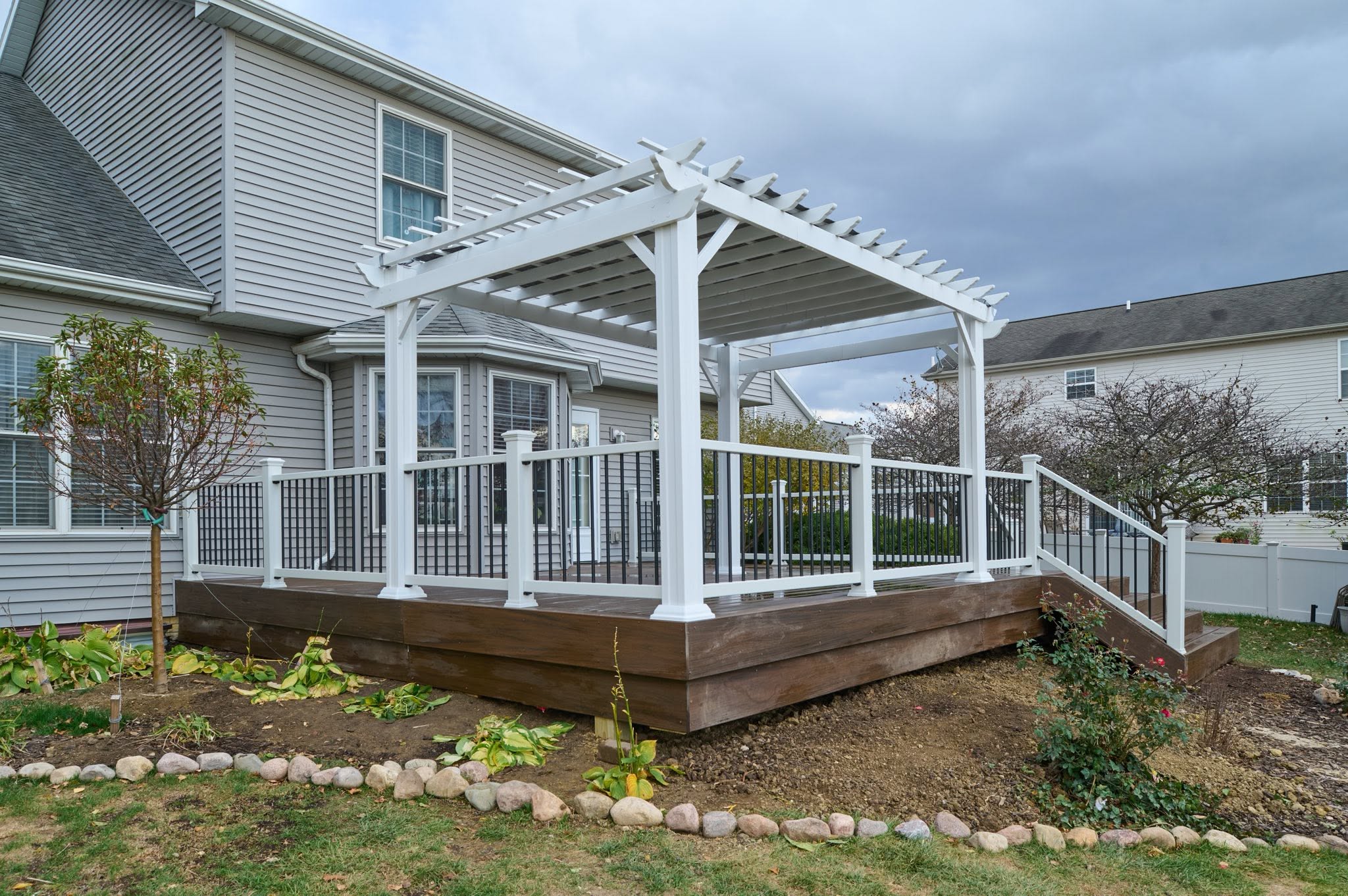 Composite deck with pergola and seating area in Normal, Illinois