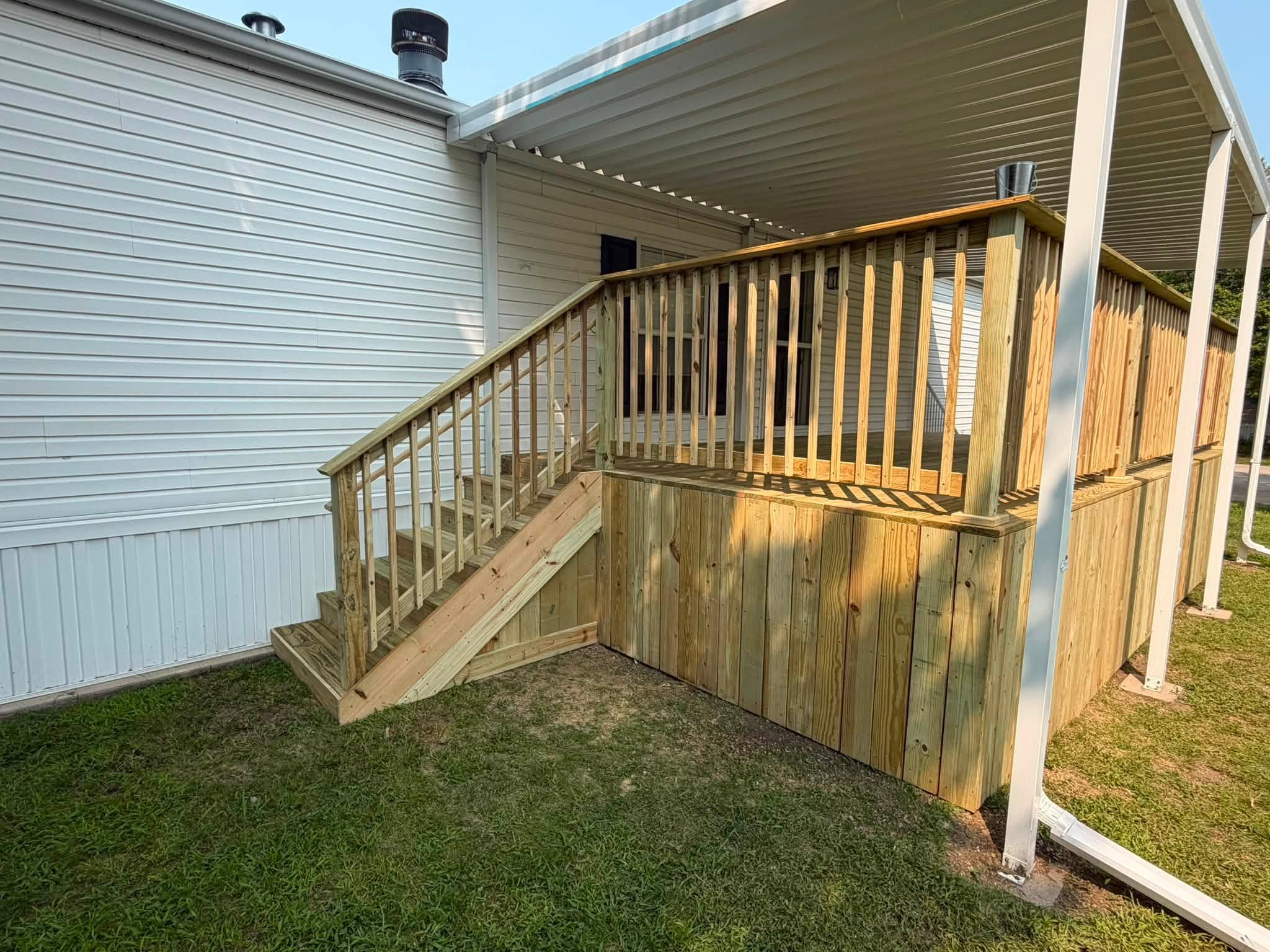 Covered deck and stairs under construction by a Draper Construction Services crew