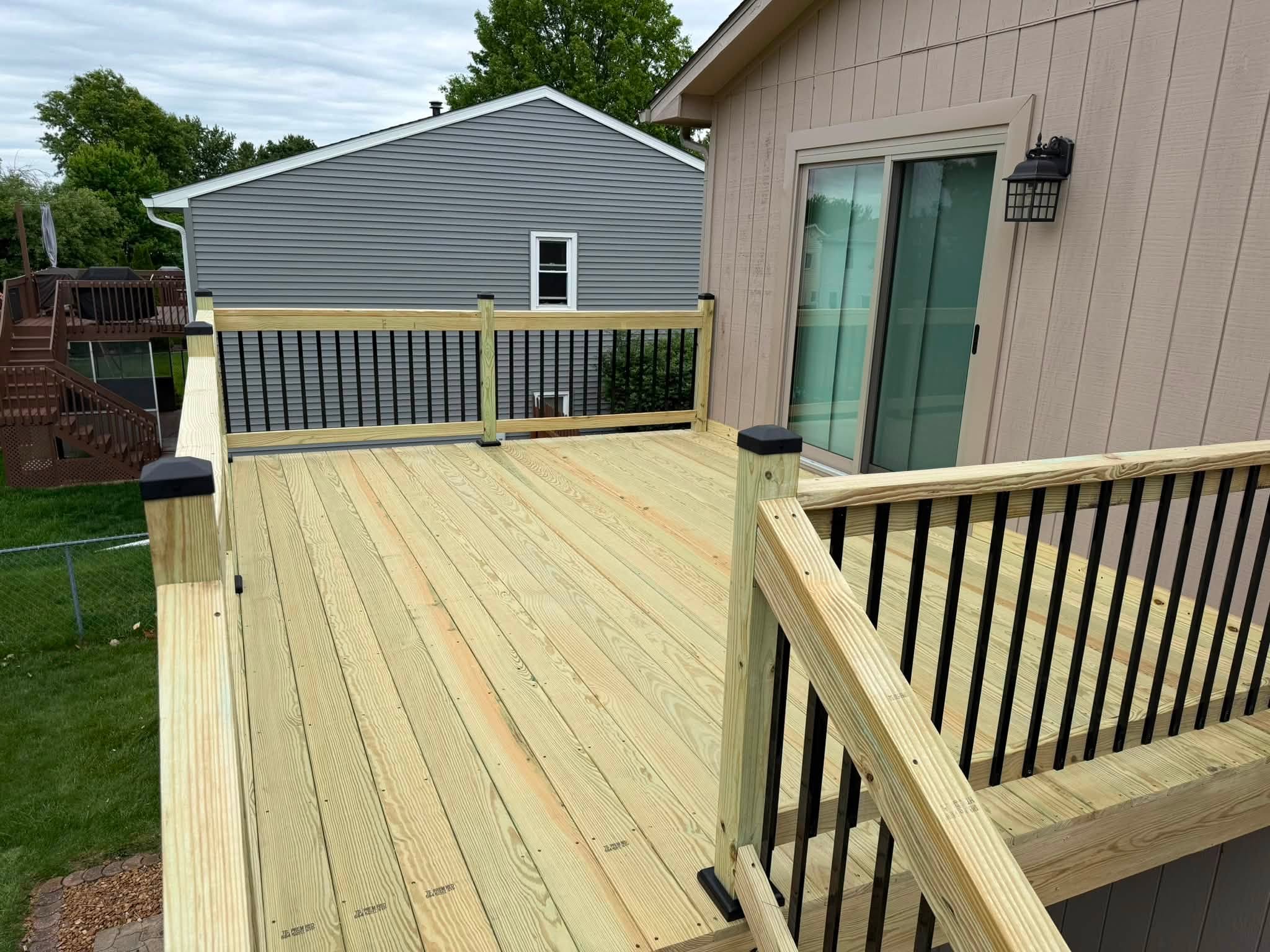 Pressure treated deck with black balusters in Bloomington, Illinois