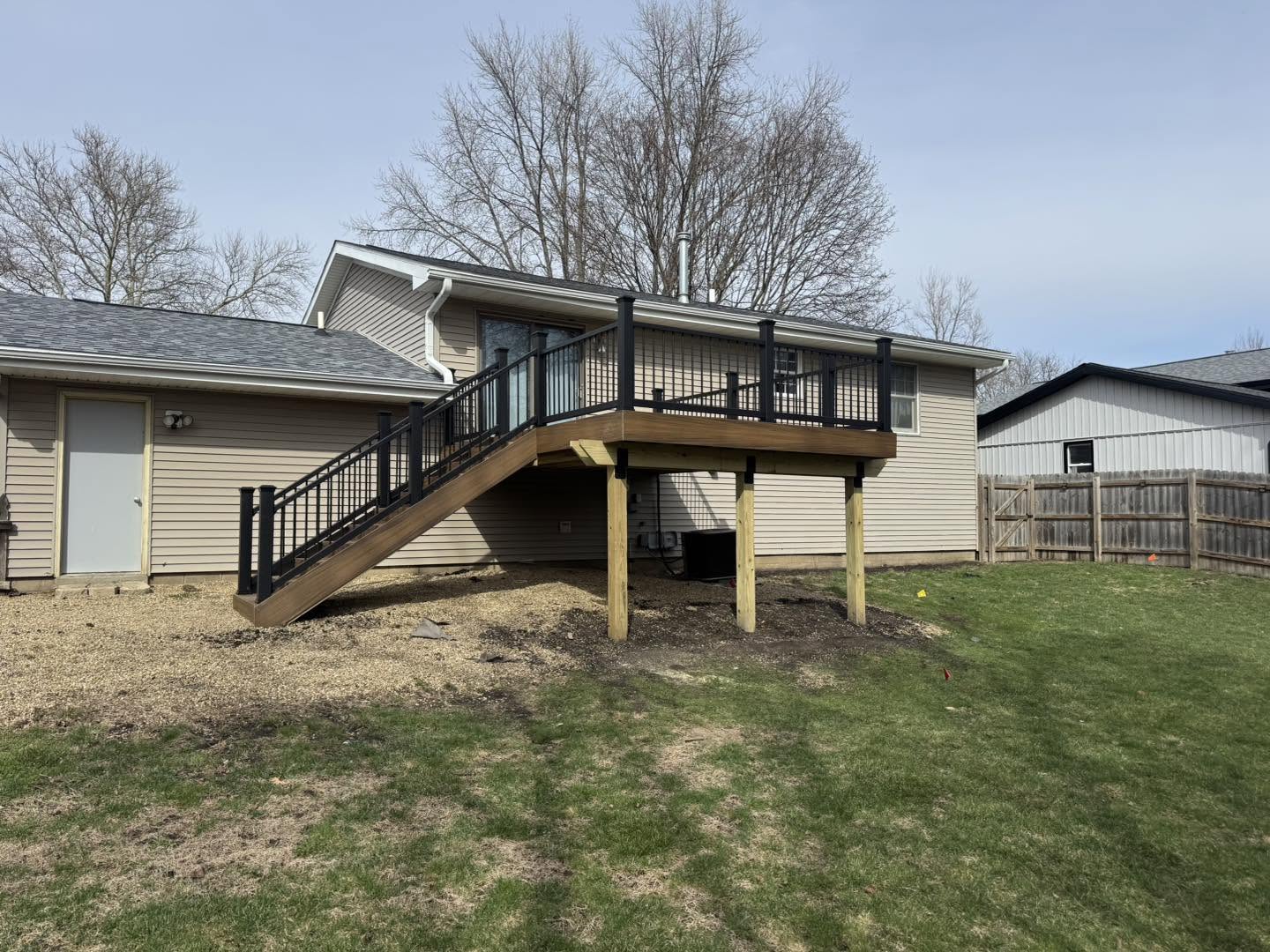 Raised composite deck with a staircase in Normal, Illinois