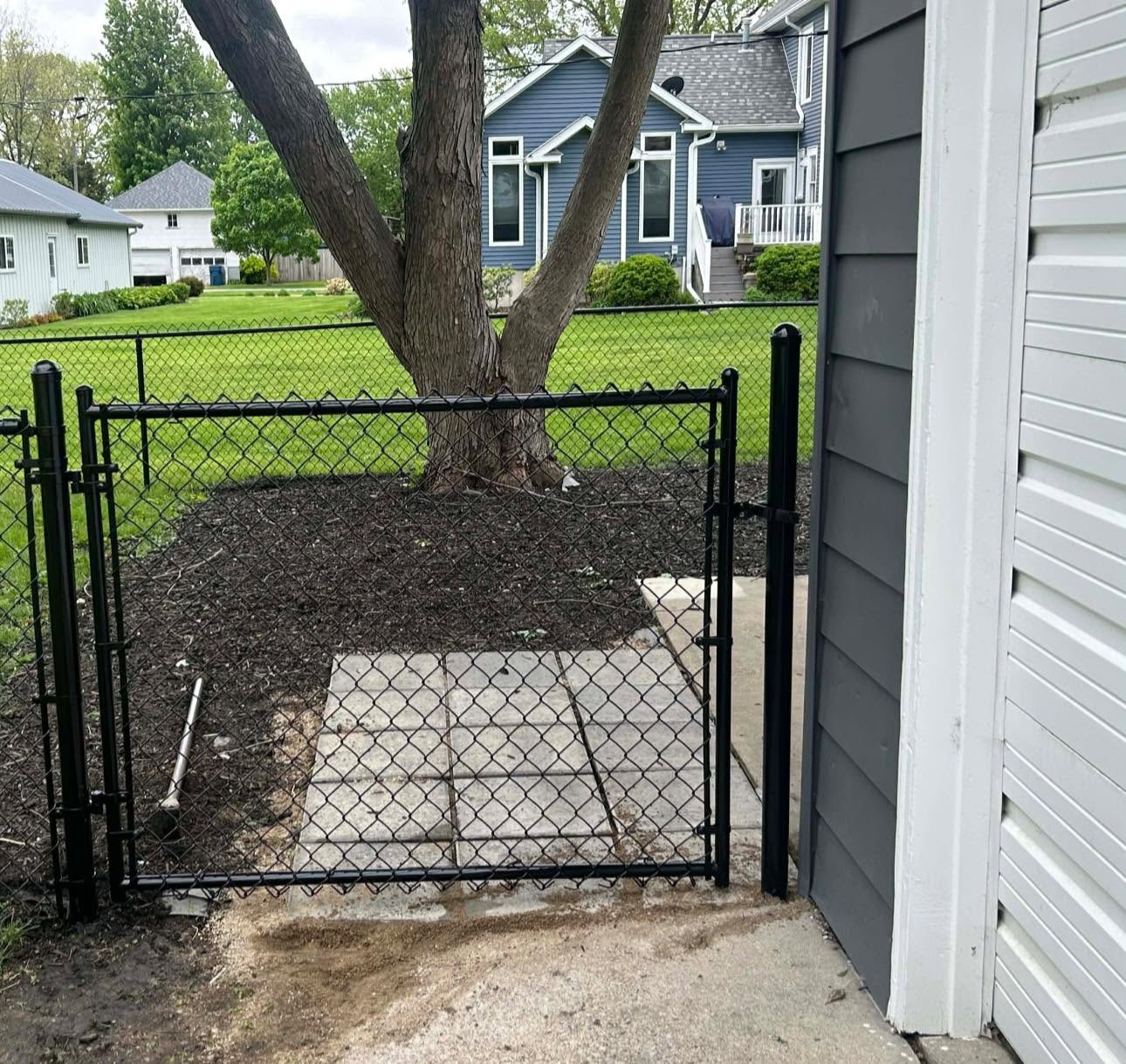 Black chain link fence with a double gate in Bloomington, Illinois