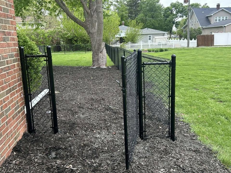 Black chain link fence with walkway gates in Normal, Illinois