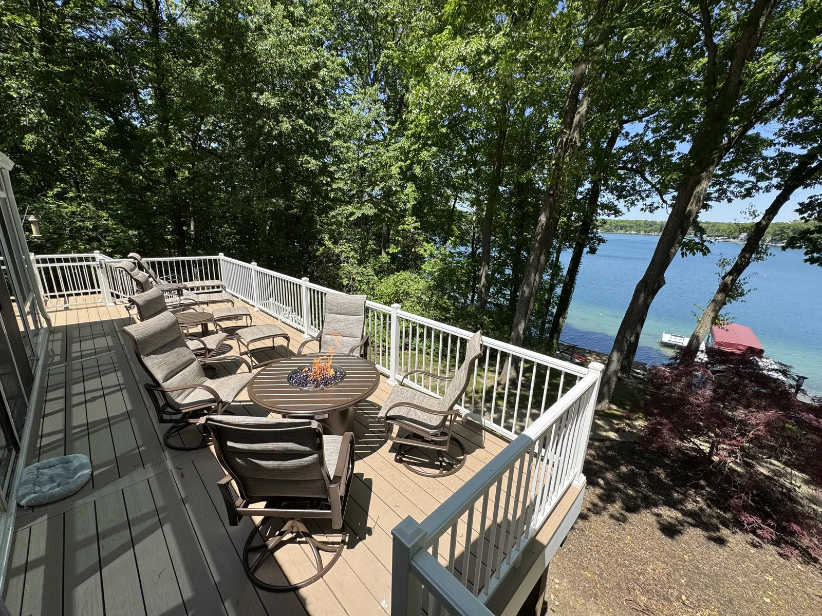 Finished TimberTech PVC deck with white aluminum railing at a lakefront home in Middleville, MI