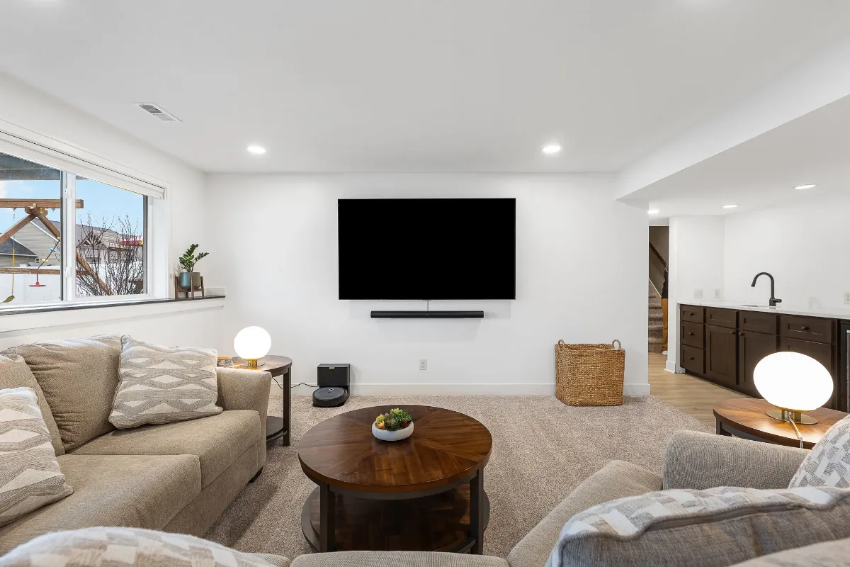 Finished basement in Grand Rapids, Michigan with a family room, wall-mounted TV and recessed lighting