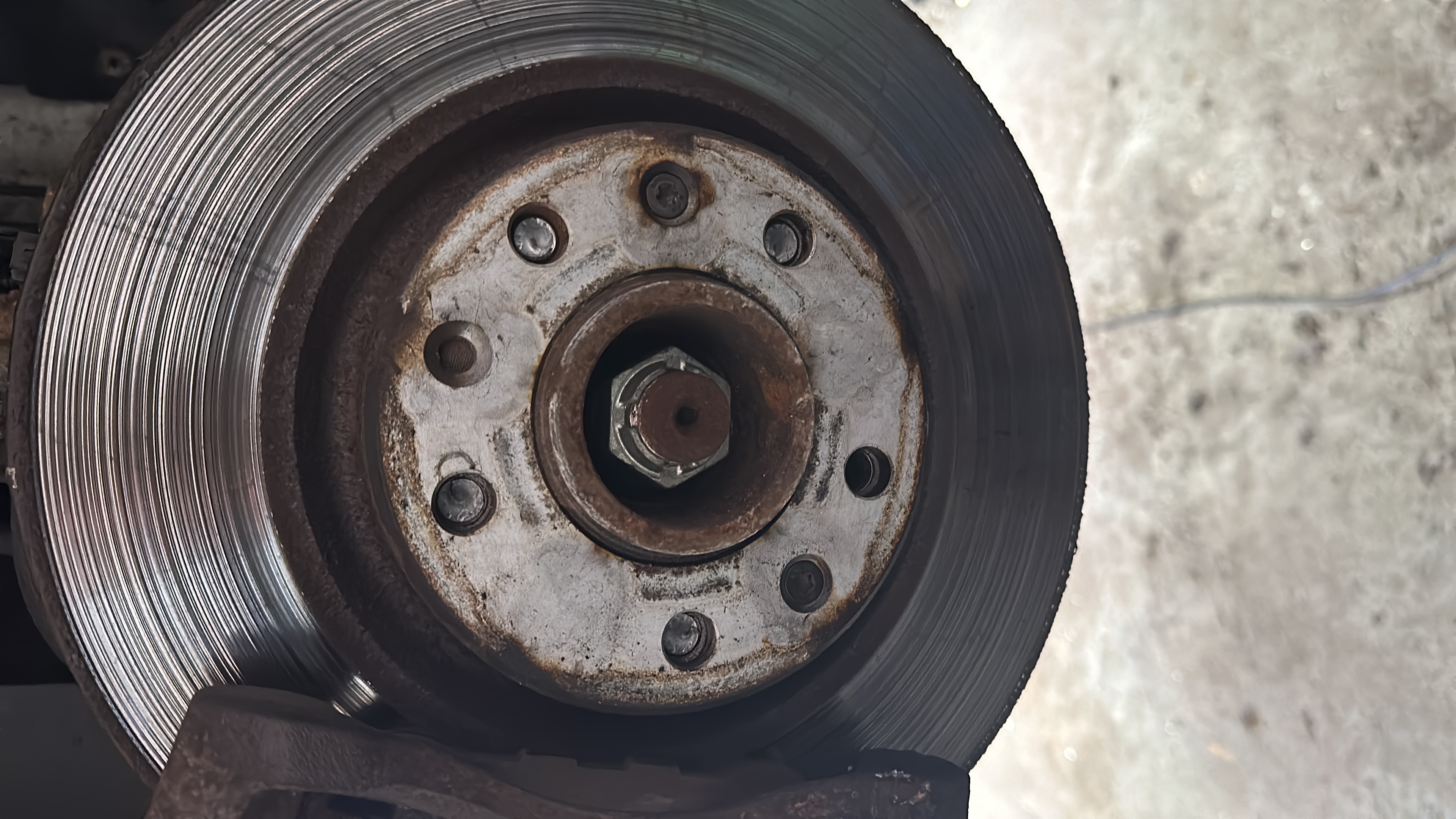 Brake disc with deep grooves and scoring caused by metal-on-metal contact at Shaw's Service Station