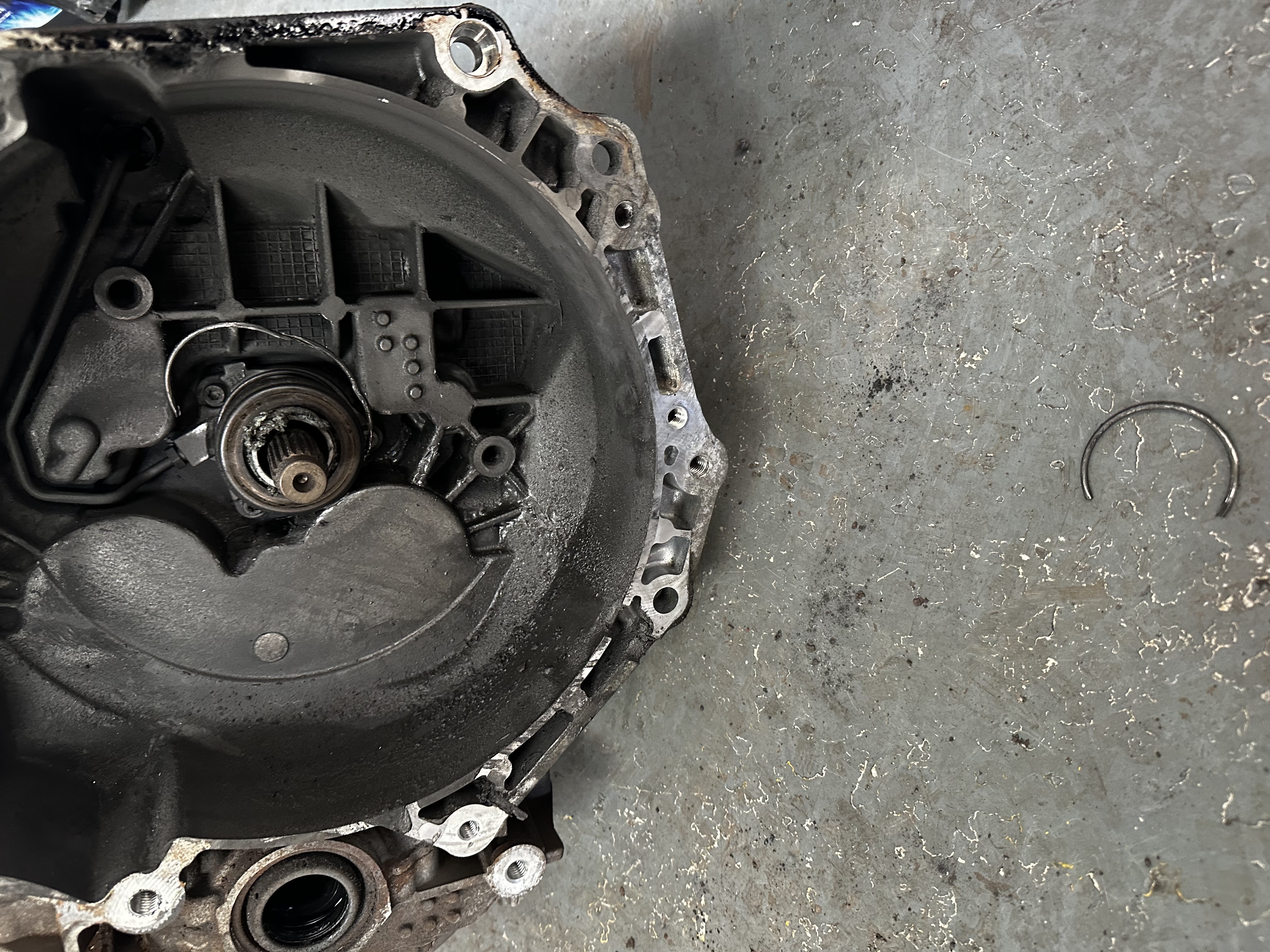 Broken snap ring from the release bearing assembly found inside the gearbox bell housing at Shaw's Service Station