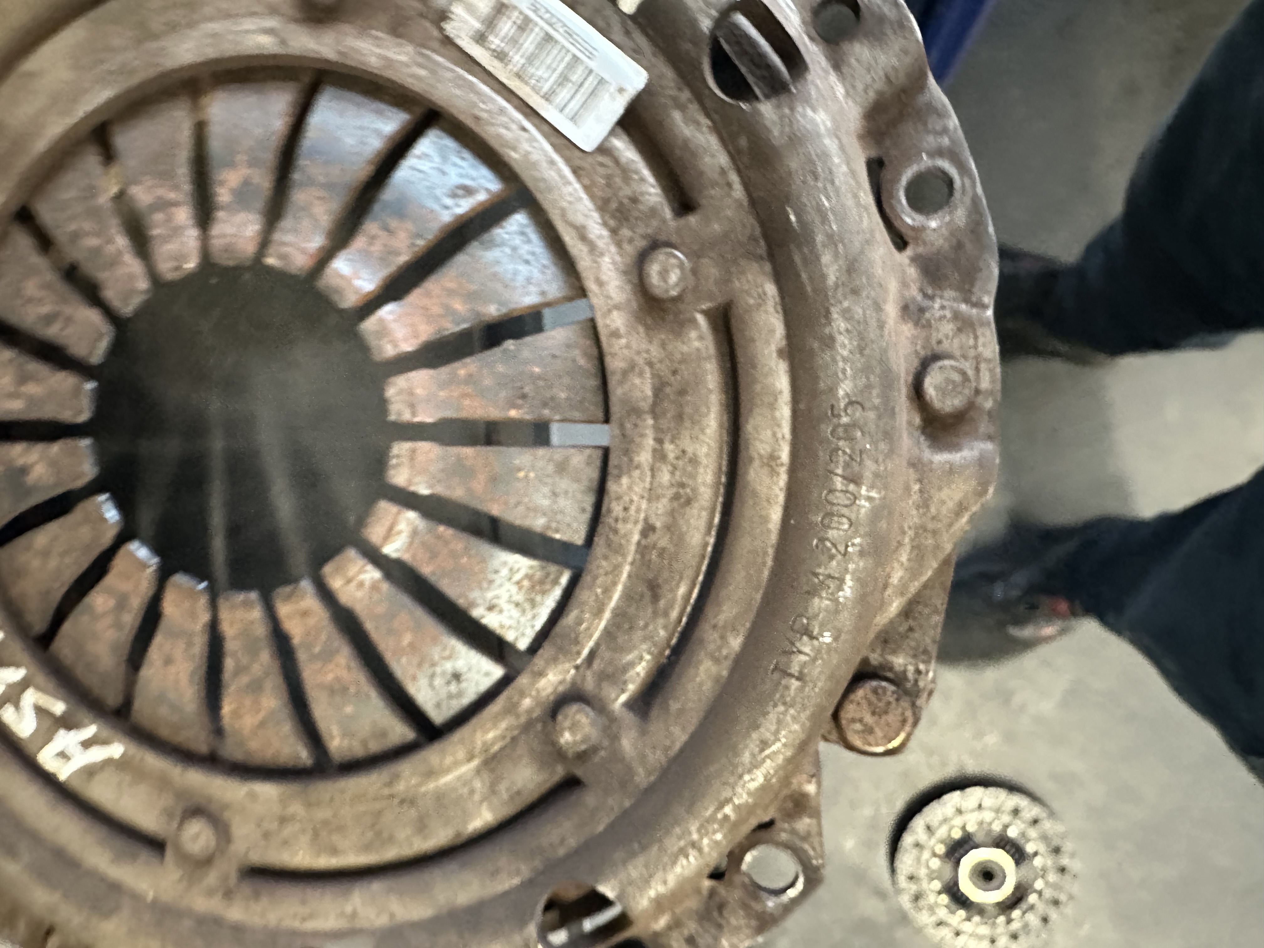 Worn and corroded clutch pressure plate removed from a vehicle at Shaw's Service Station