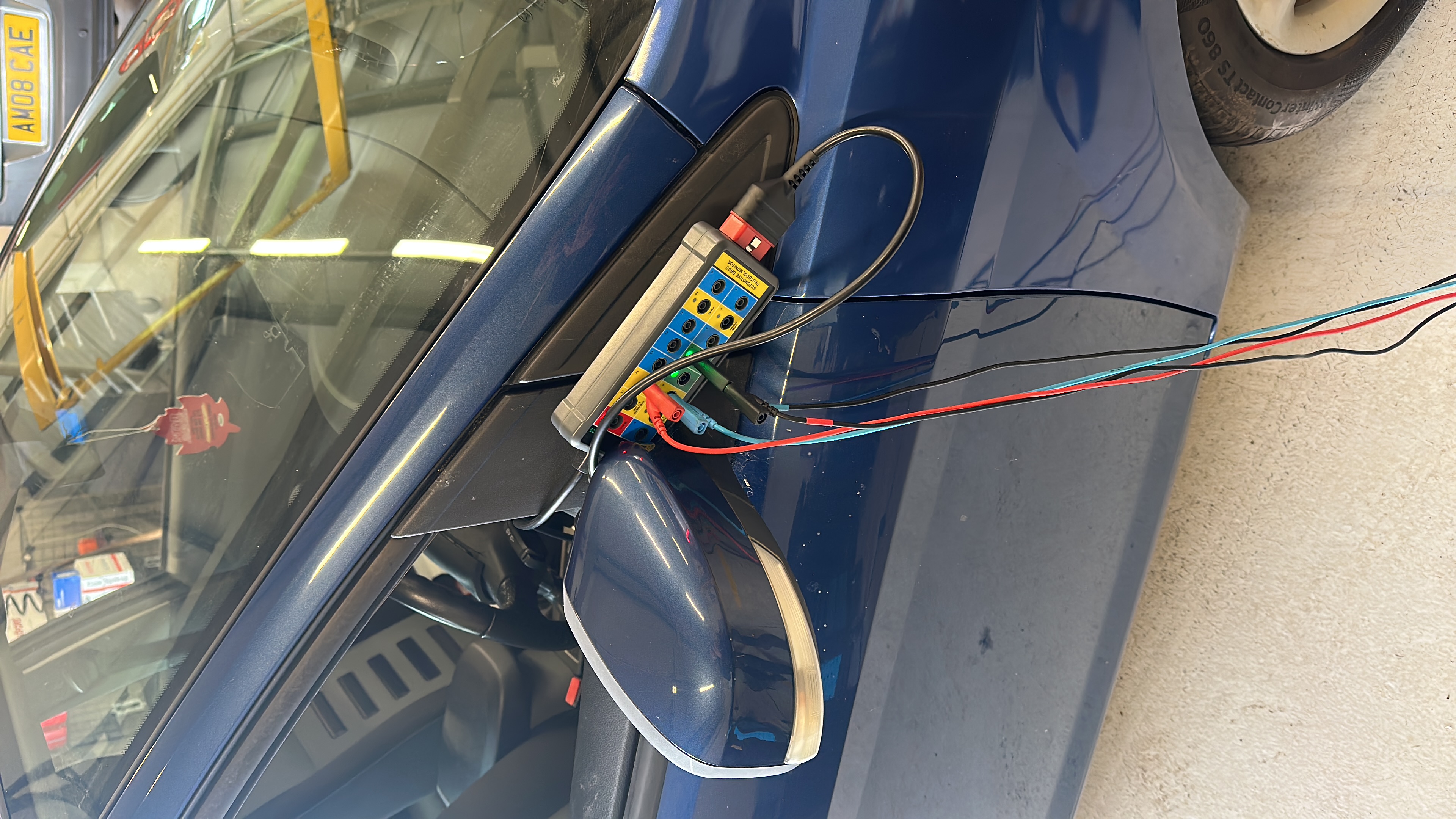 Electrical breakout box attached to vehicle wiring connector for circuit testing at Shaw's Service Station