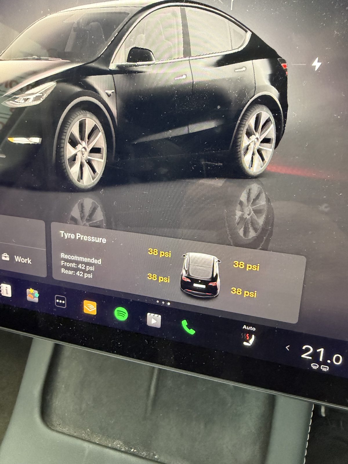 A Tesla touchscreen showing the tyre pressure for each of the four tyres
