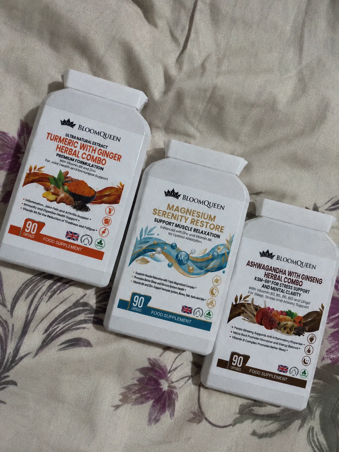 BloomQueen Recovery Bundle — three supplement bottles on a bedside table next to a lamp and an open book