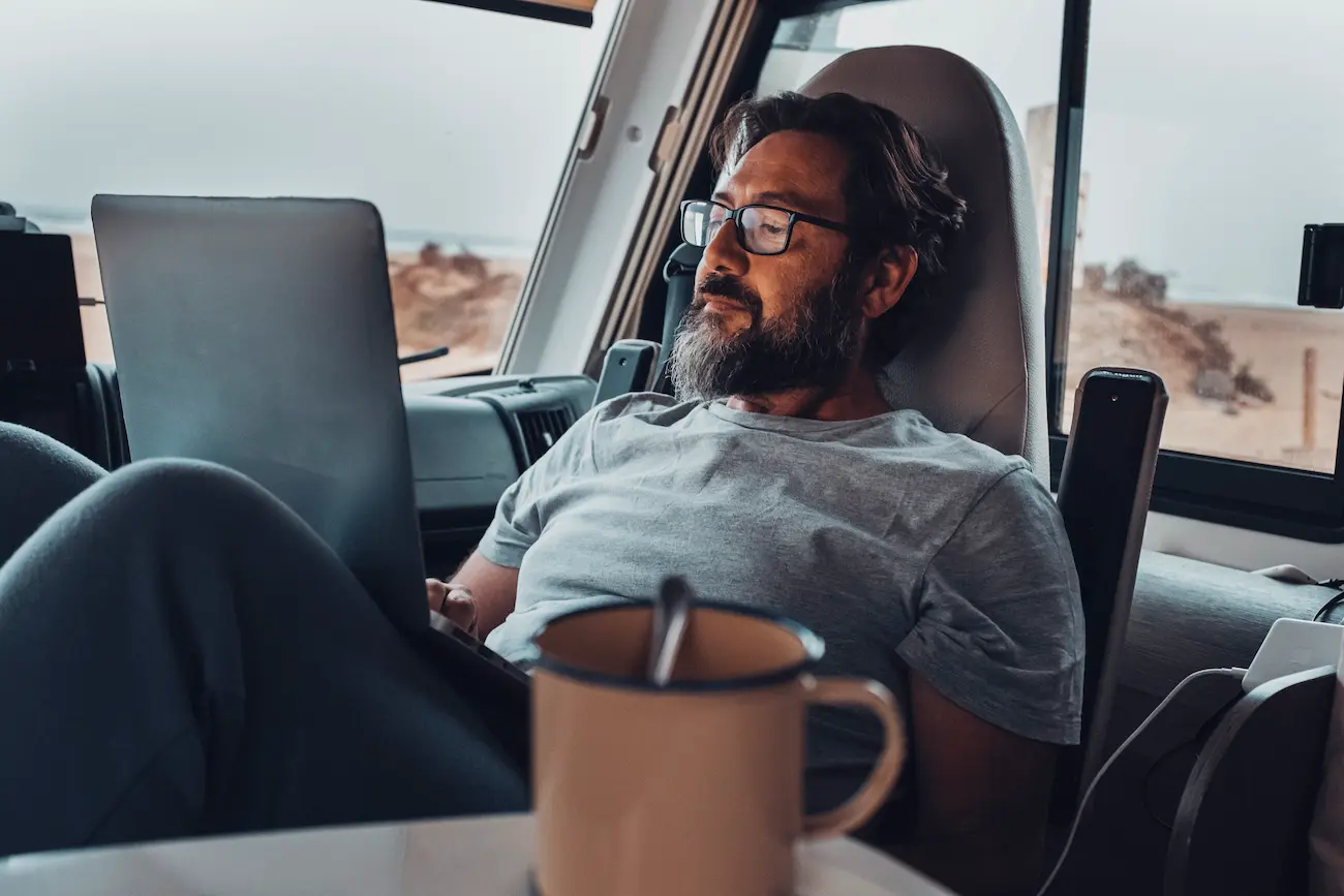 Digital nomad working from an RV with a laptop