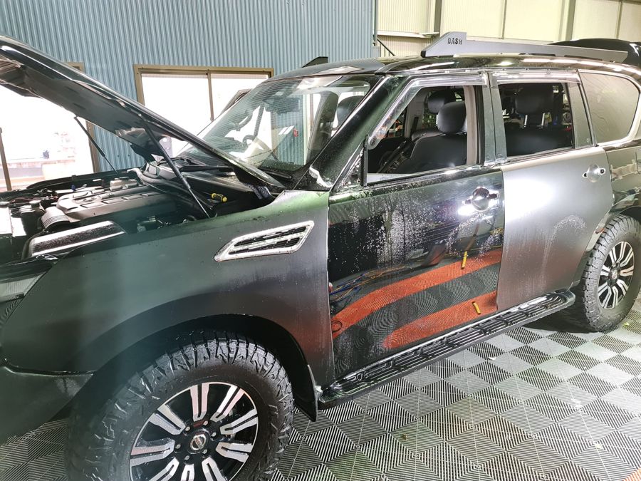 Nissan Patrol getting film fitted in the booth