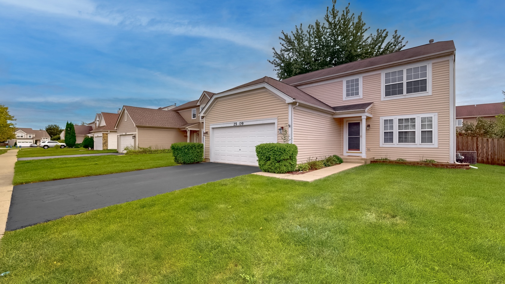 Front of 2509 Rosehall Lane, a two-story home with a two-car attached garage
