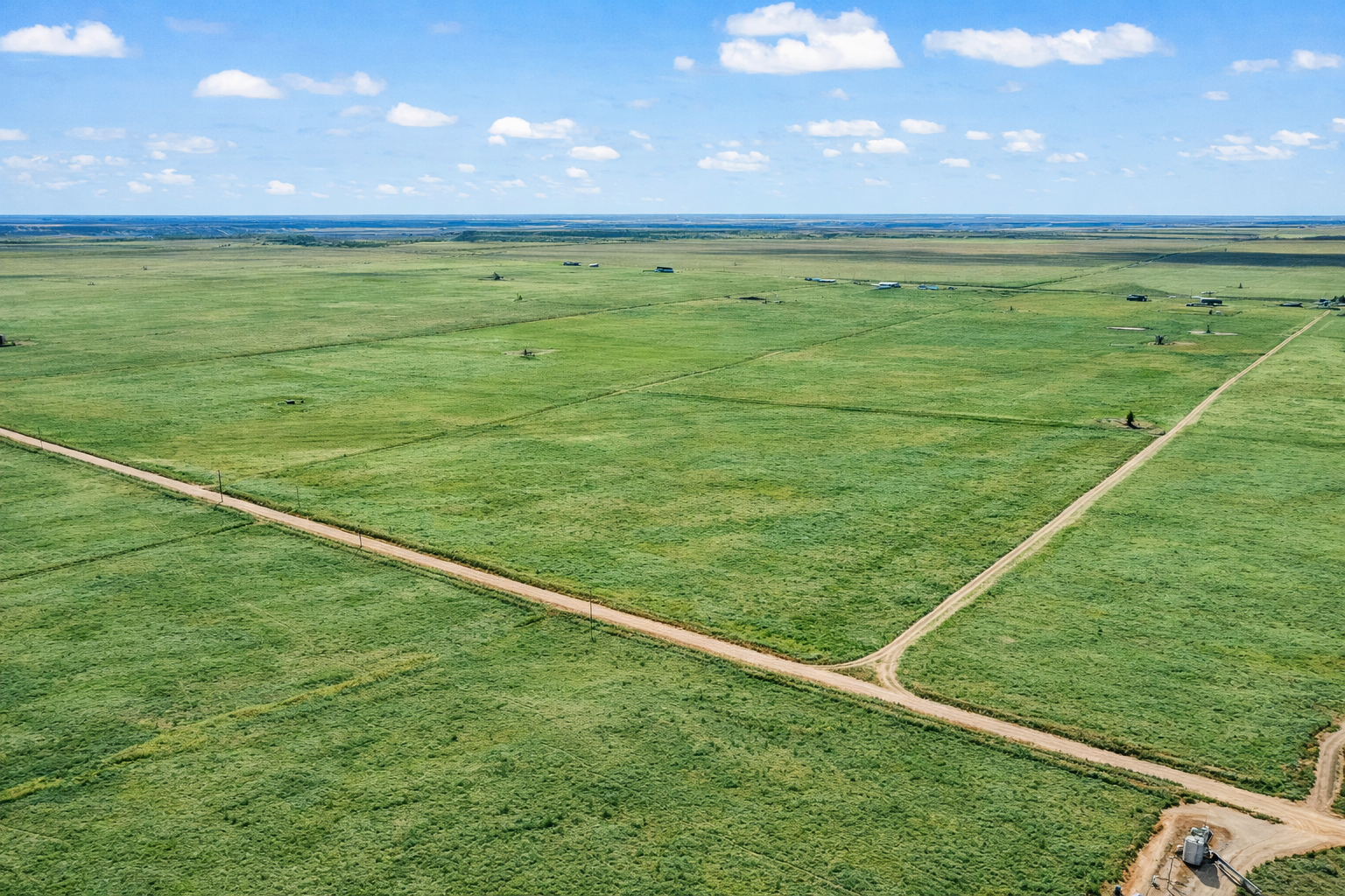 Aerial view of green farmland and dirt roads at Titan Farms east of Lubbock, Texas