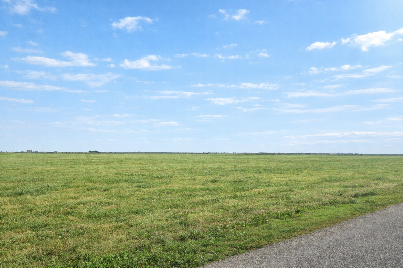 Open grassland next to a paved road near Corpus Christi, Texas