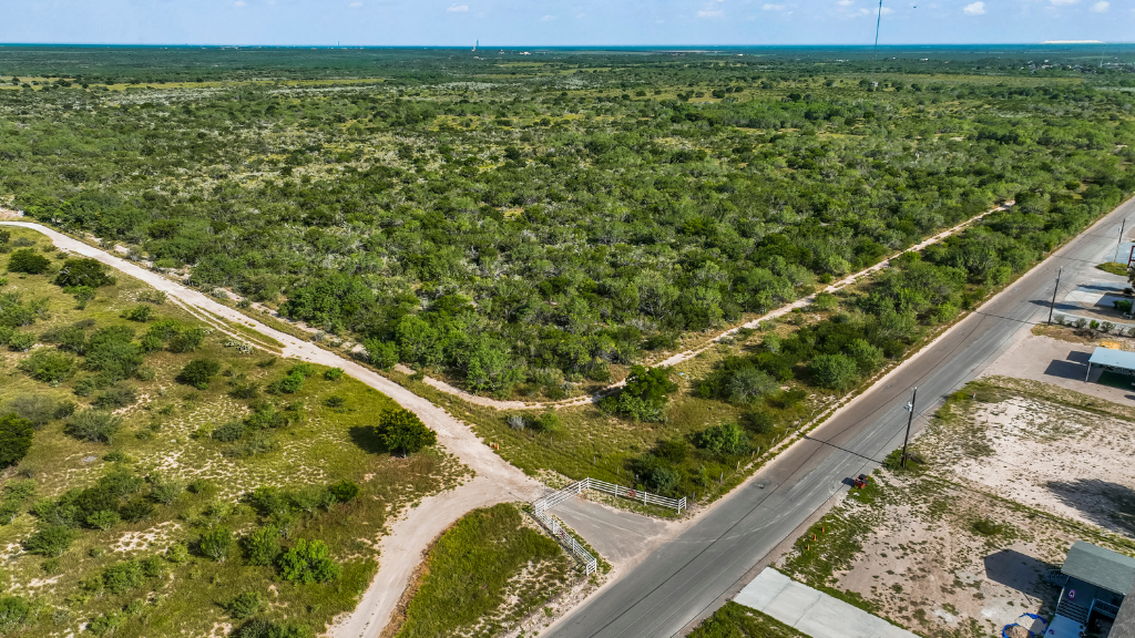Aerial view of brush land beside a paved road at Junior Oaks near Rio Grande City, Texas