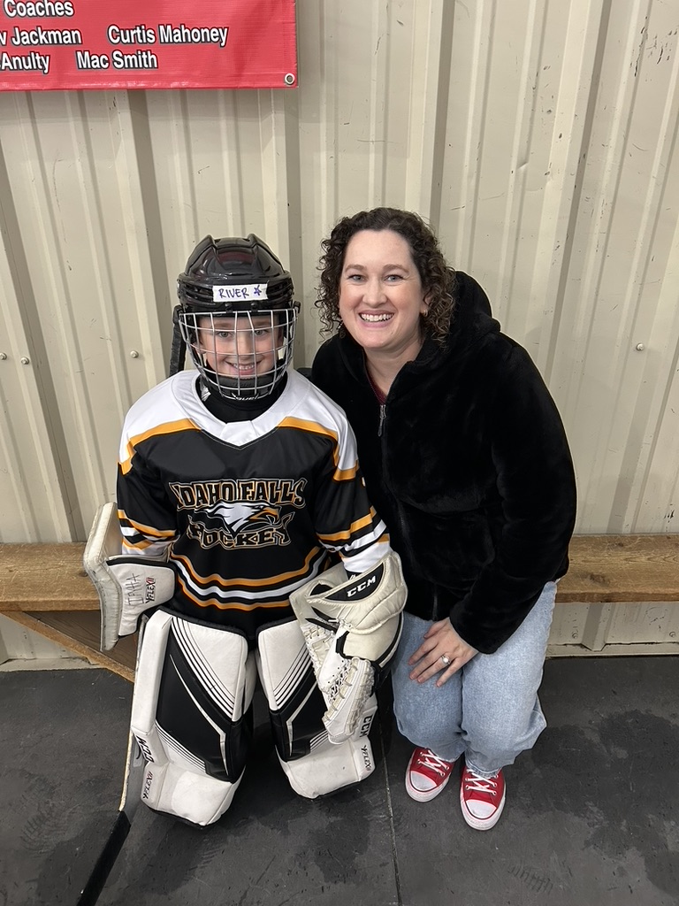 Kelly next to her son in hockey uniform